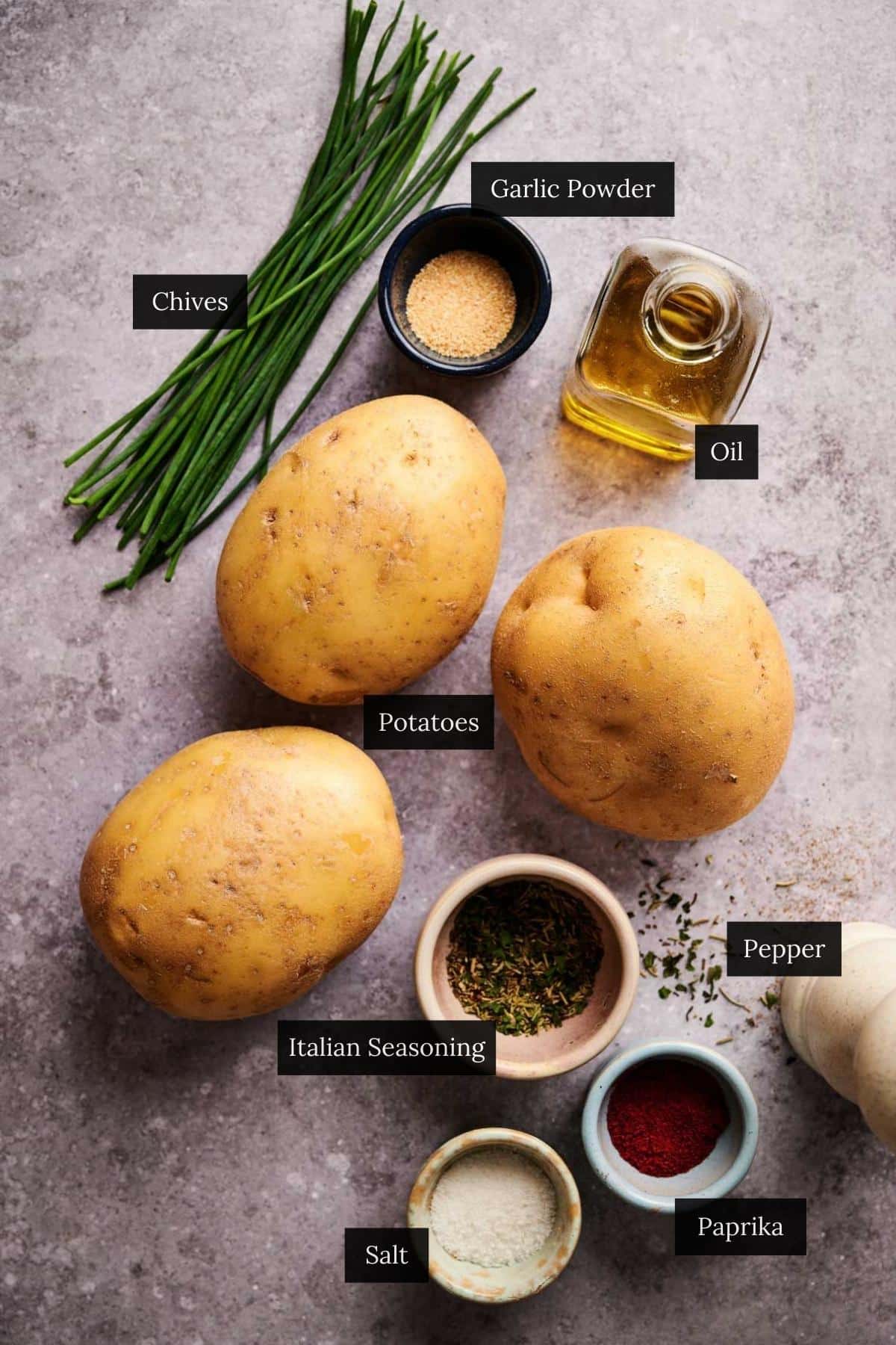 Ingredients for home fries on a counter with each ingredient labeled.