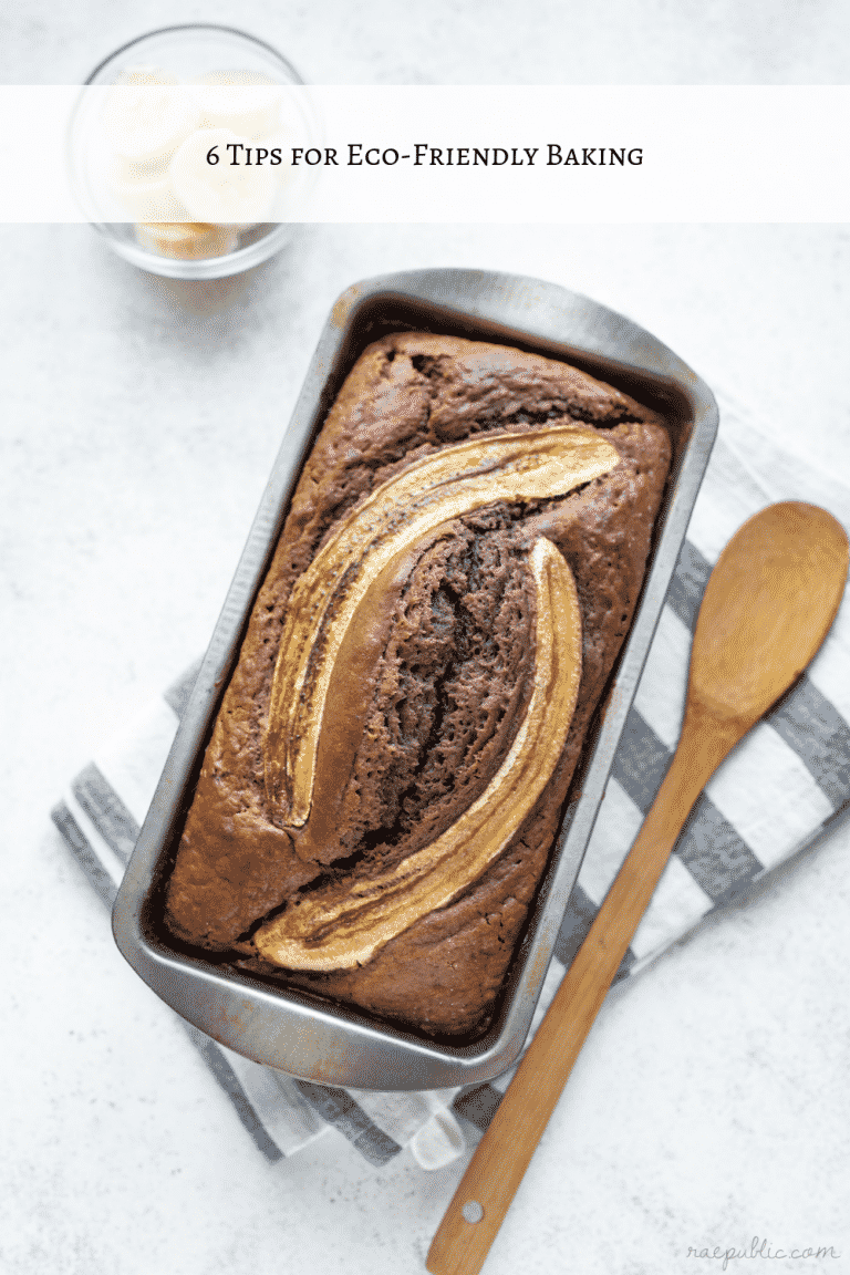 Banana bread in a loaf pan on top of a linen towel.