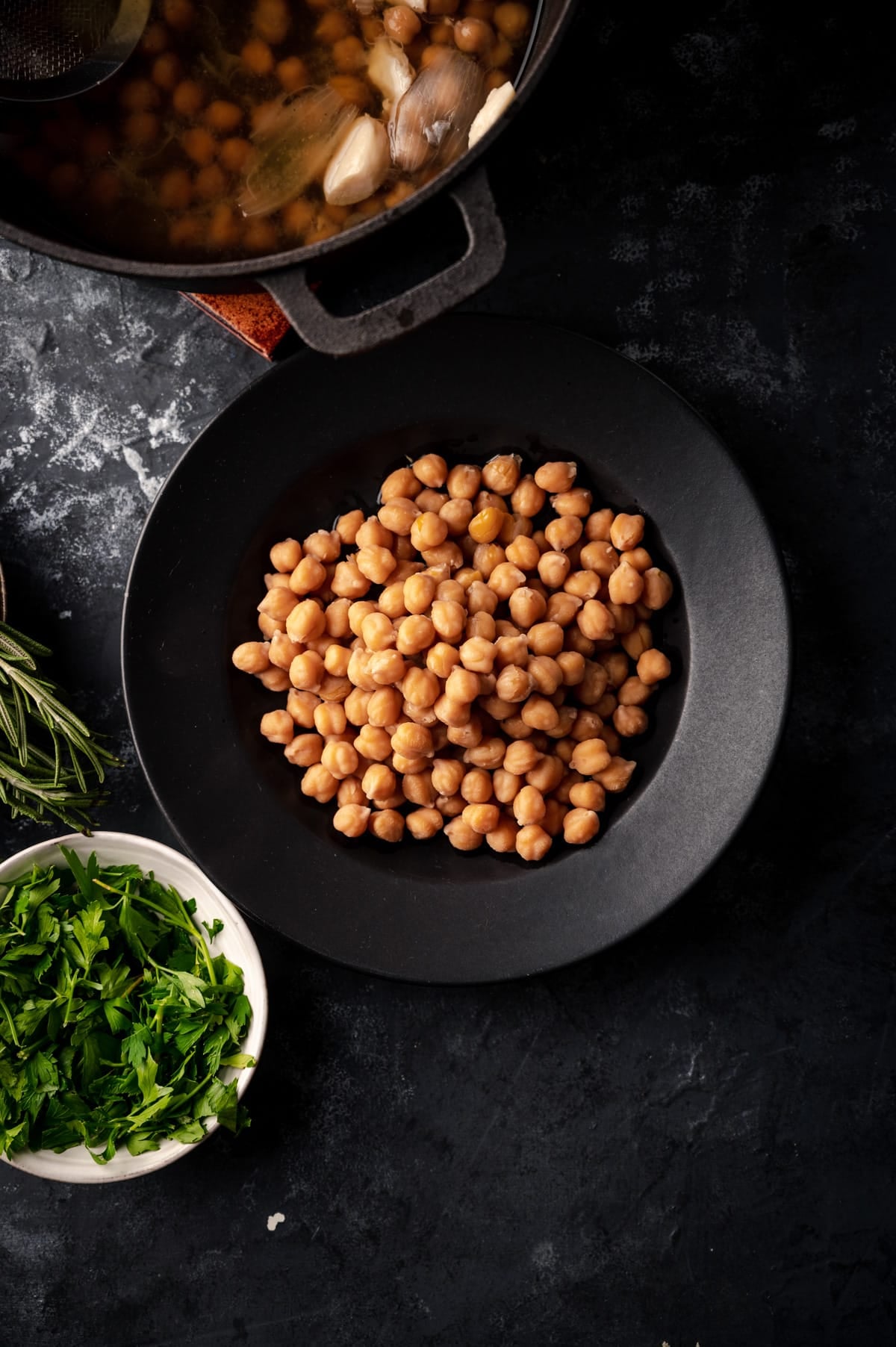 Cooking chickpeas is easy, here is a photo of cooked garbanzo beans with fresh herbs on the side.
