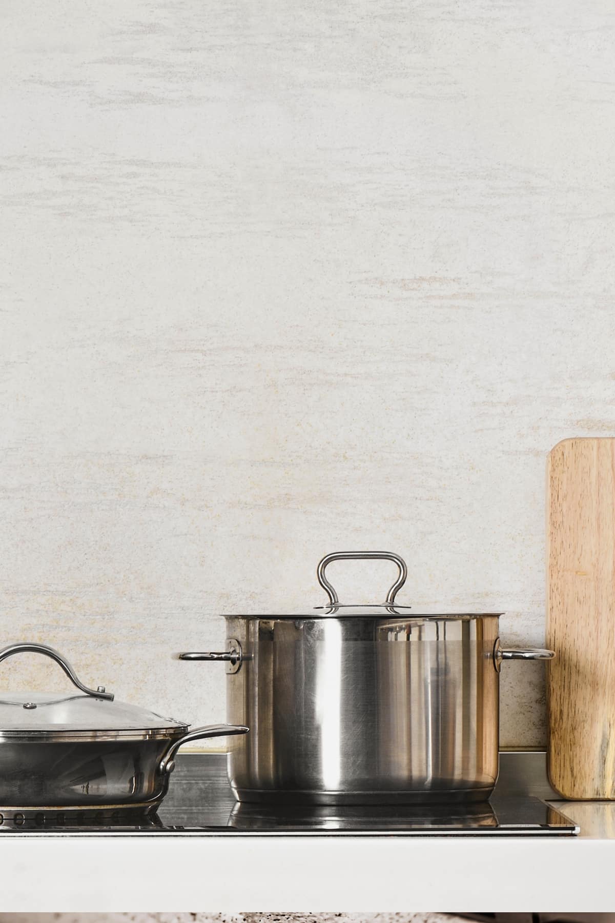 Stainless steel soup pot on top of an induction cooktop. 