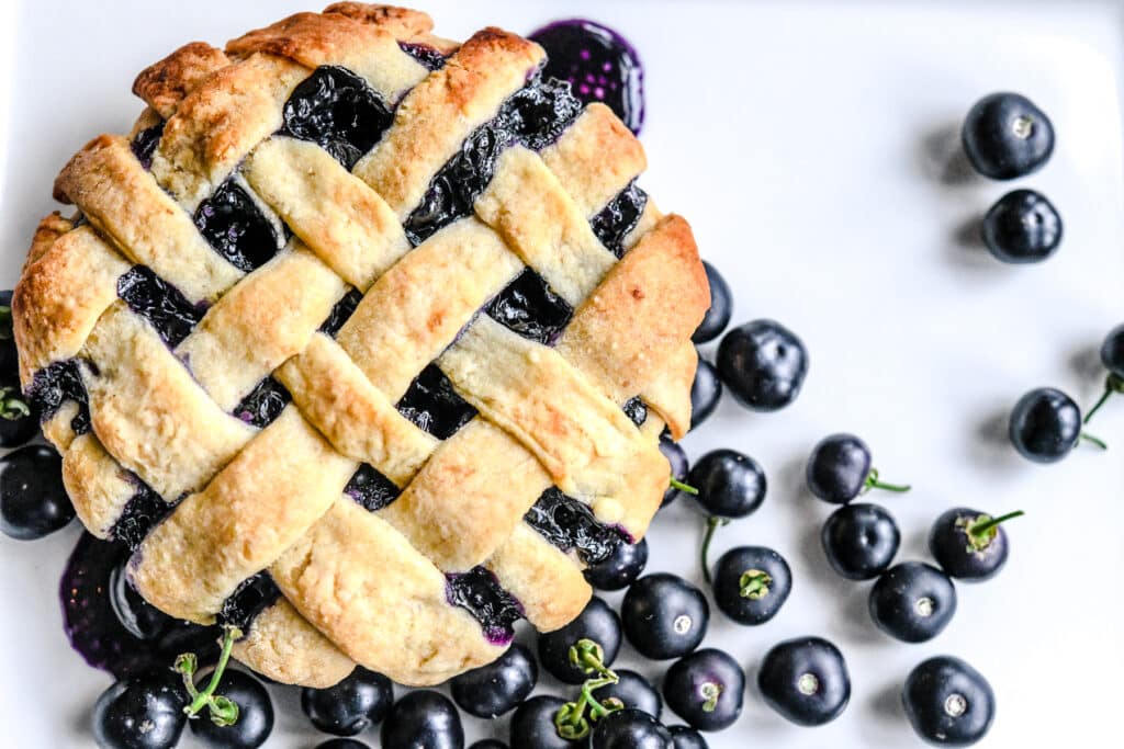 Garden Berry Huckleberry baked in a pie on a white surface.