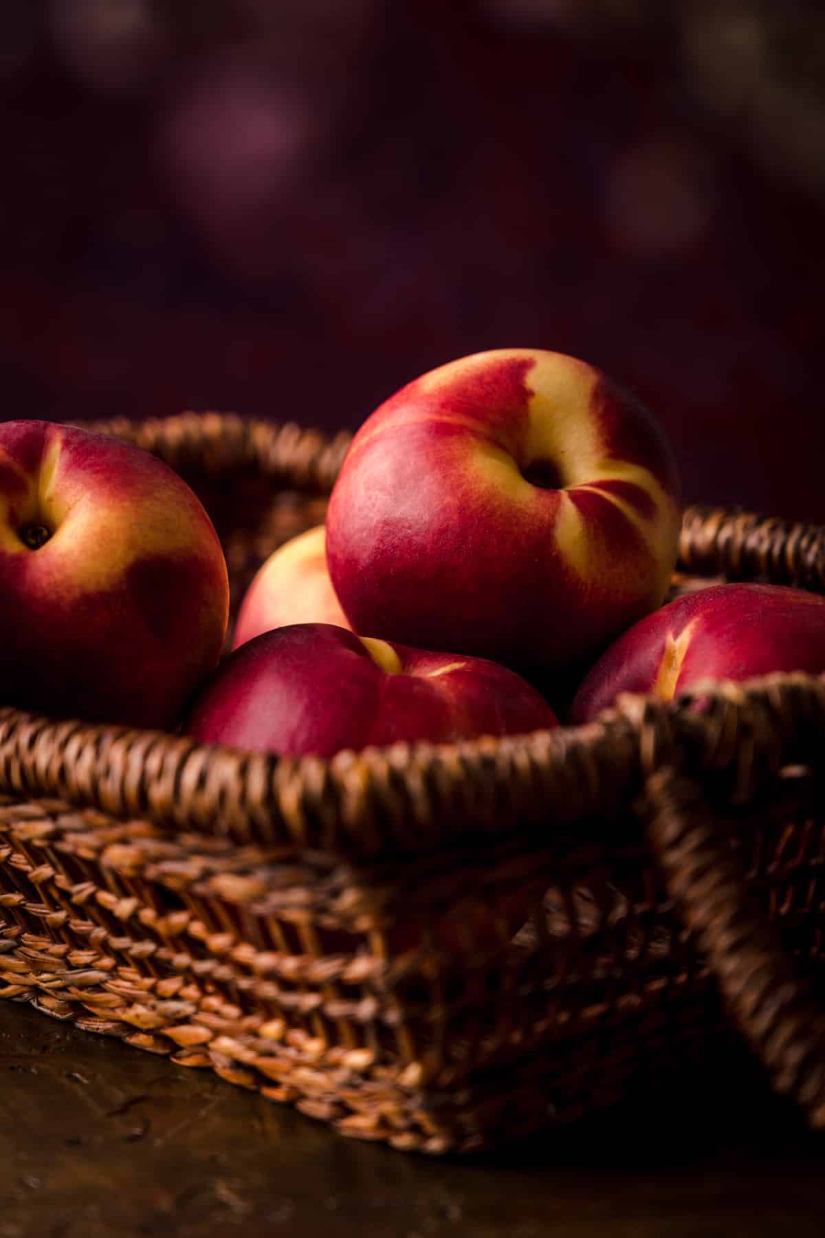 Fresh peaches in a basket ready to freeze.