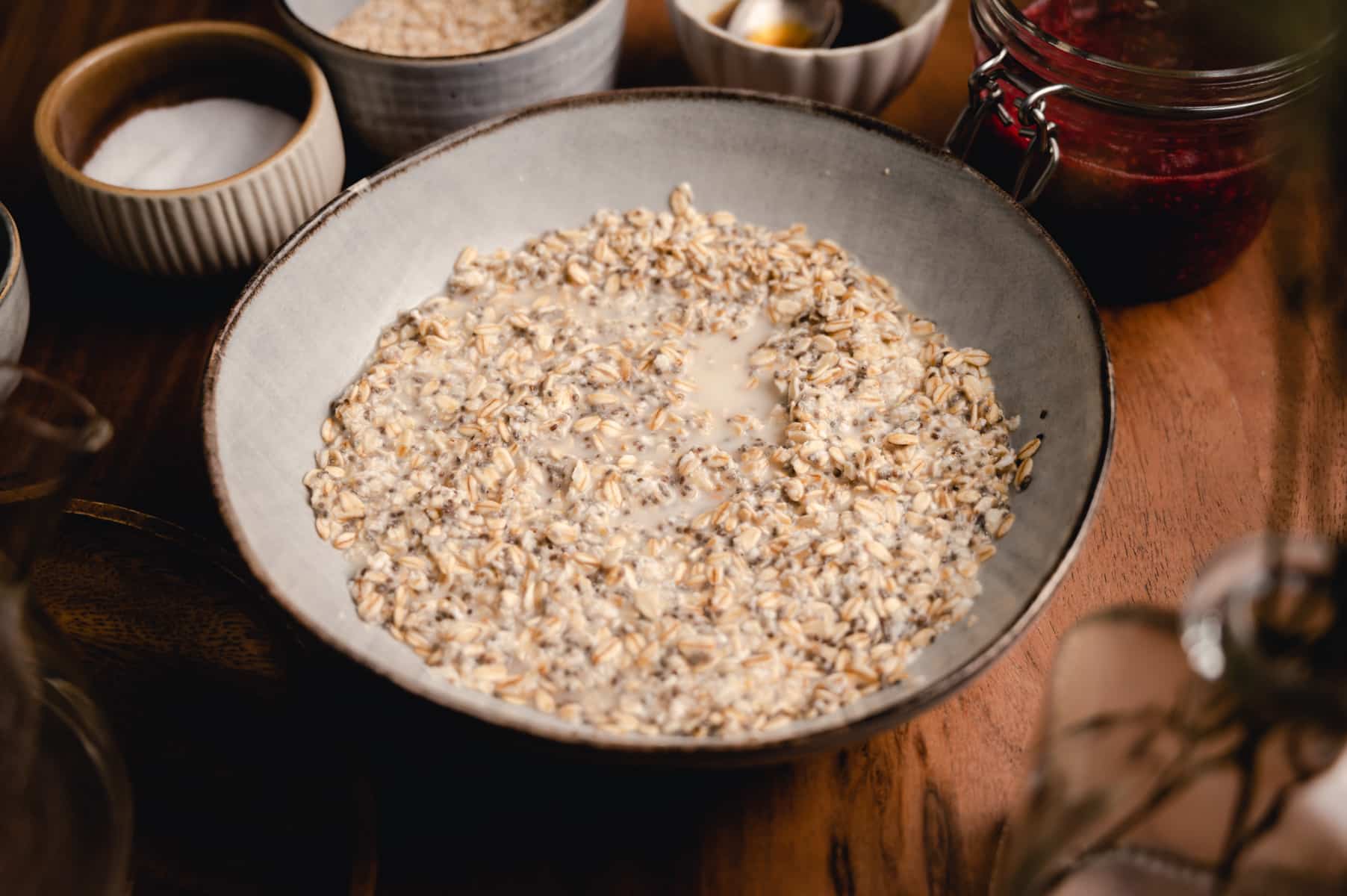 Bowl of rolled oats with chia seeds and the hot water soaked in.