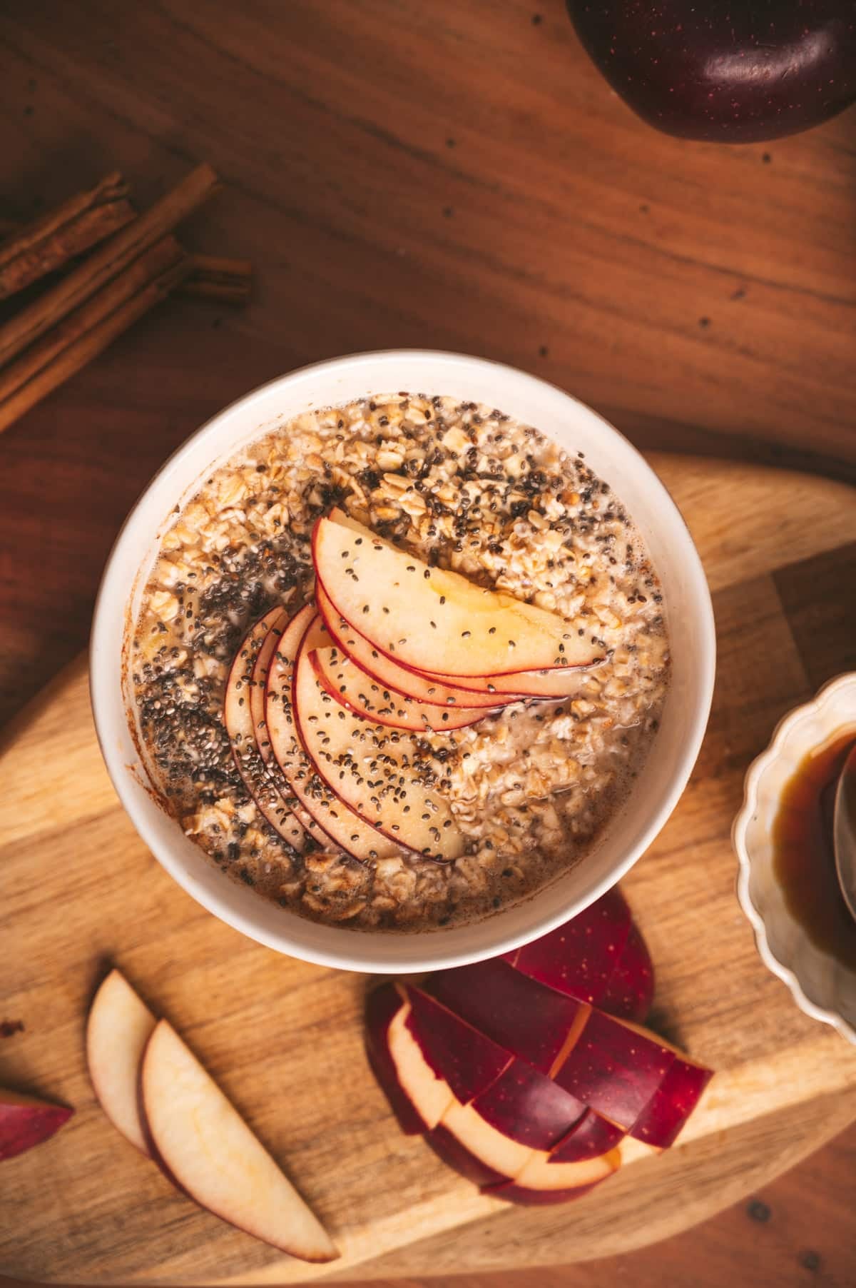 Flatlay photo of apple cinnamon oatmeal with sliced apples fanned out on top.