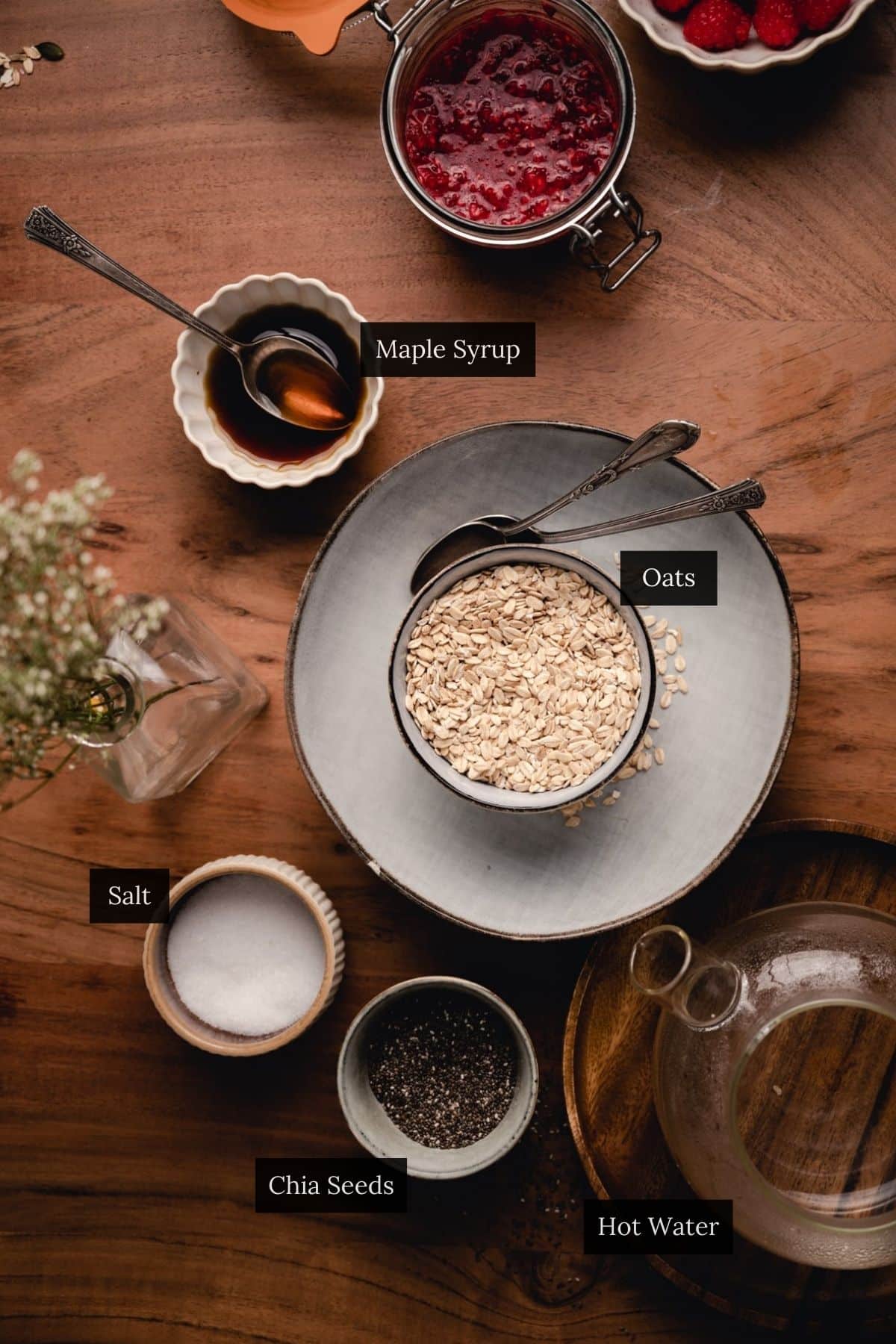 Bowl of rolled oats surrounded by ingredients for chia oatmeal.