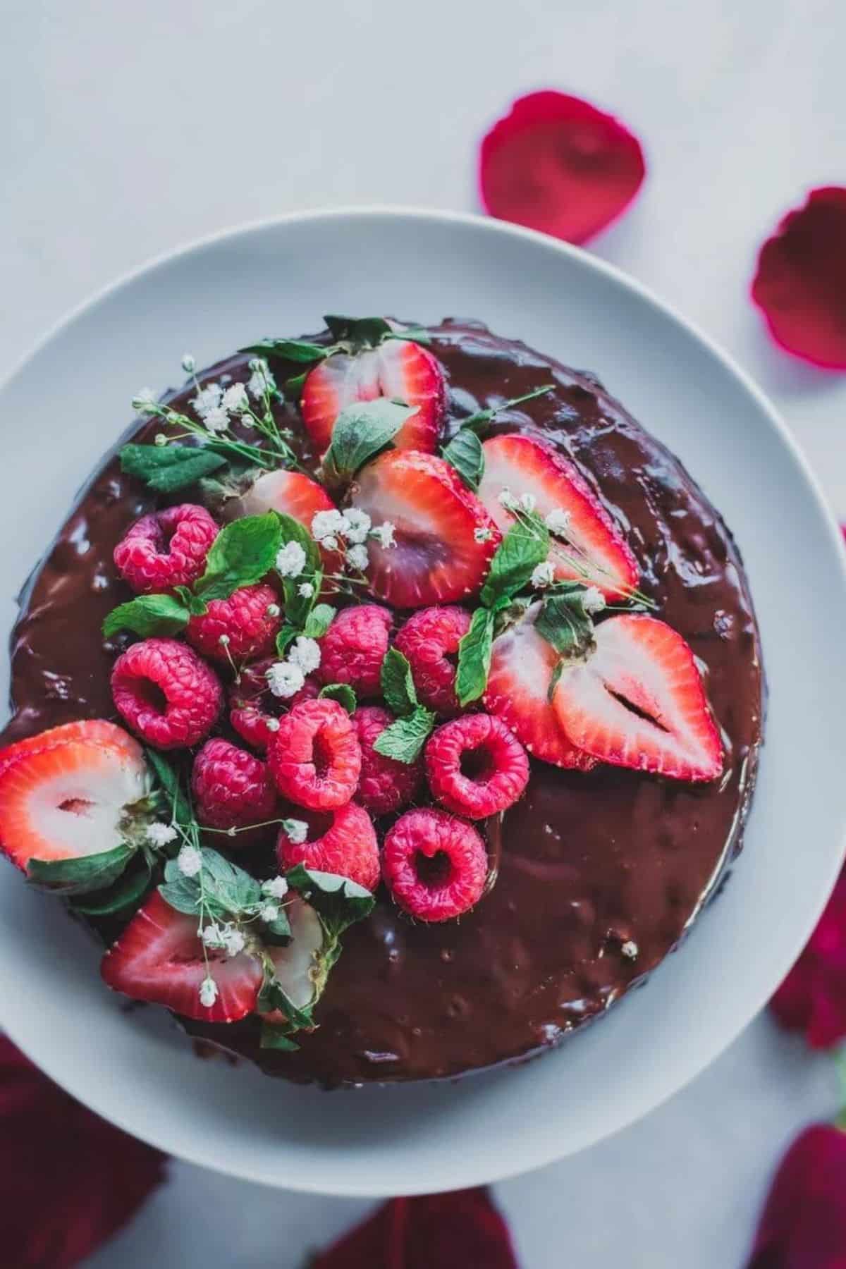 Chocolate cake topped with chocolate frosting and fresh berries.