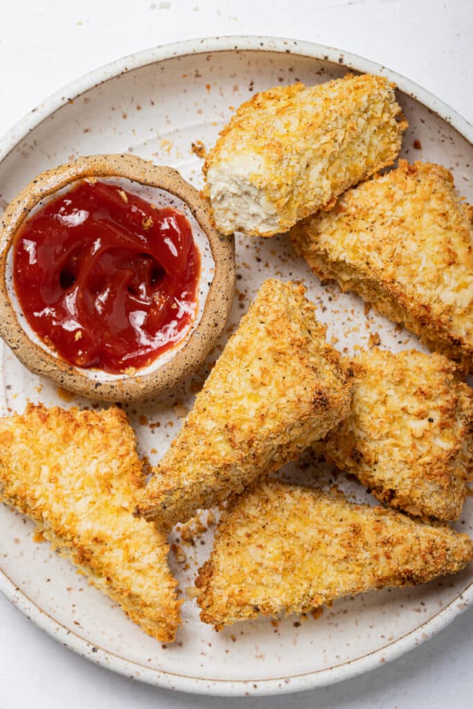 A plate with vegan fried bread sticks and tofu.