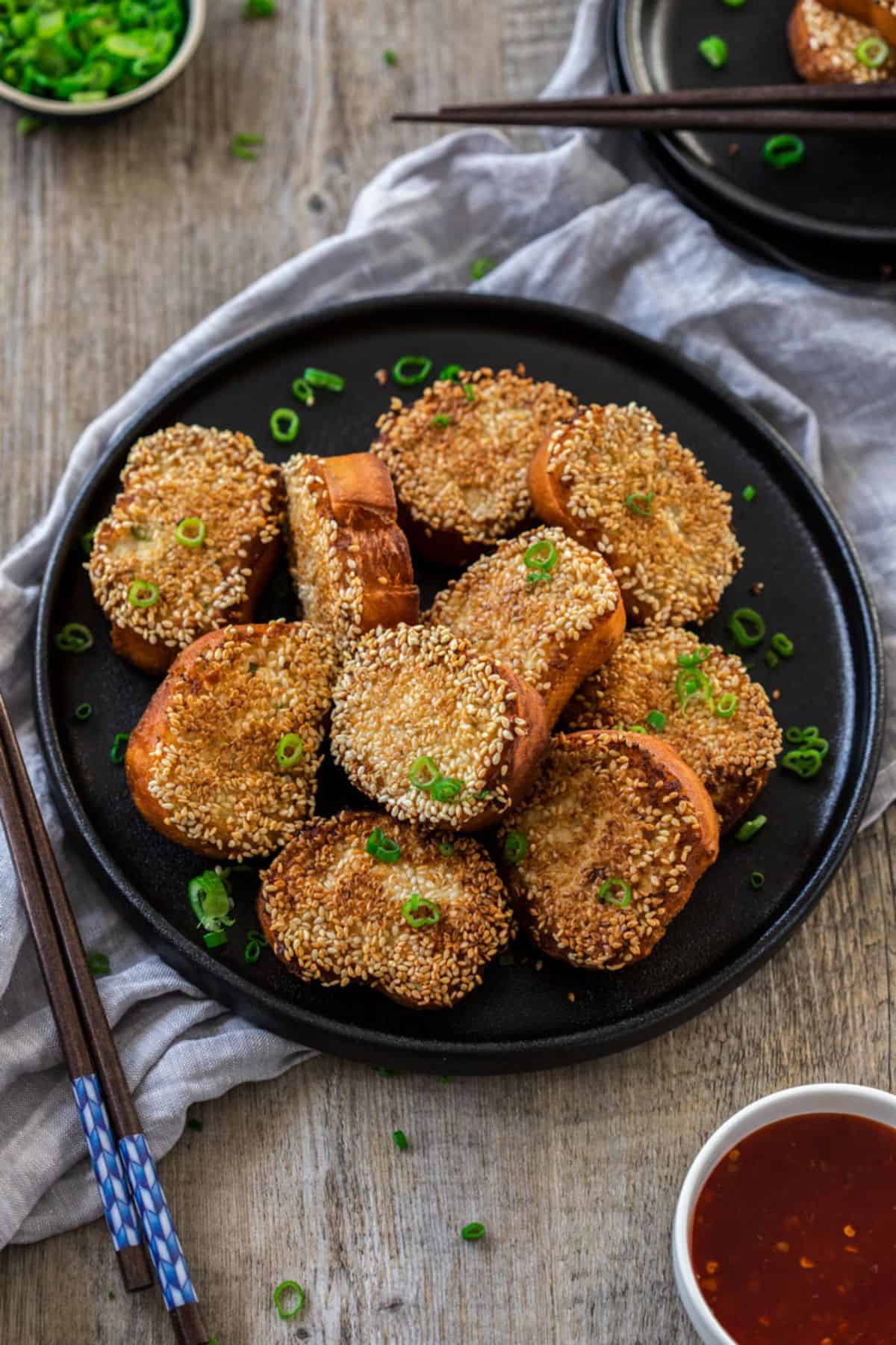 A plate of vegan fried bread with tofu sauce, served with chopsticks.