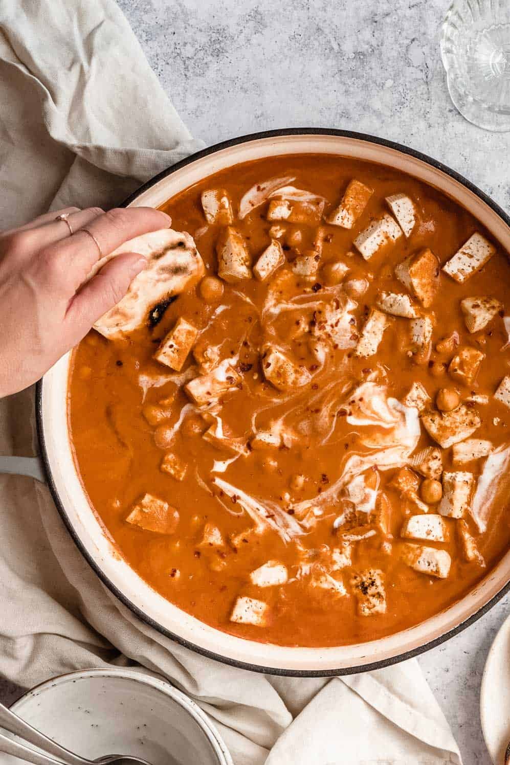 A person enjoying a delicious bowl of vegan soup.
