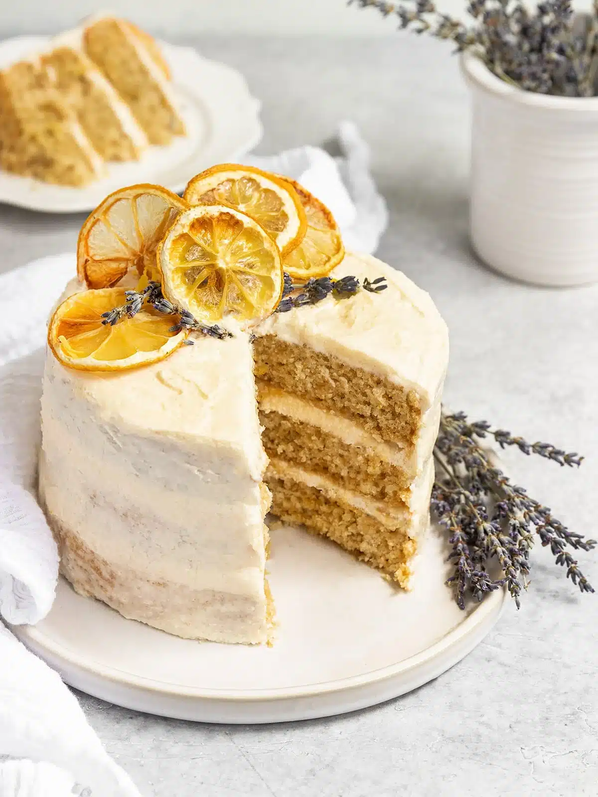 Lemon lavender cake with creamy frosting topped with dried lemons.