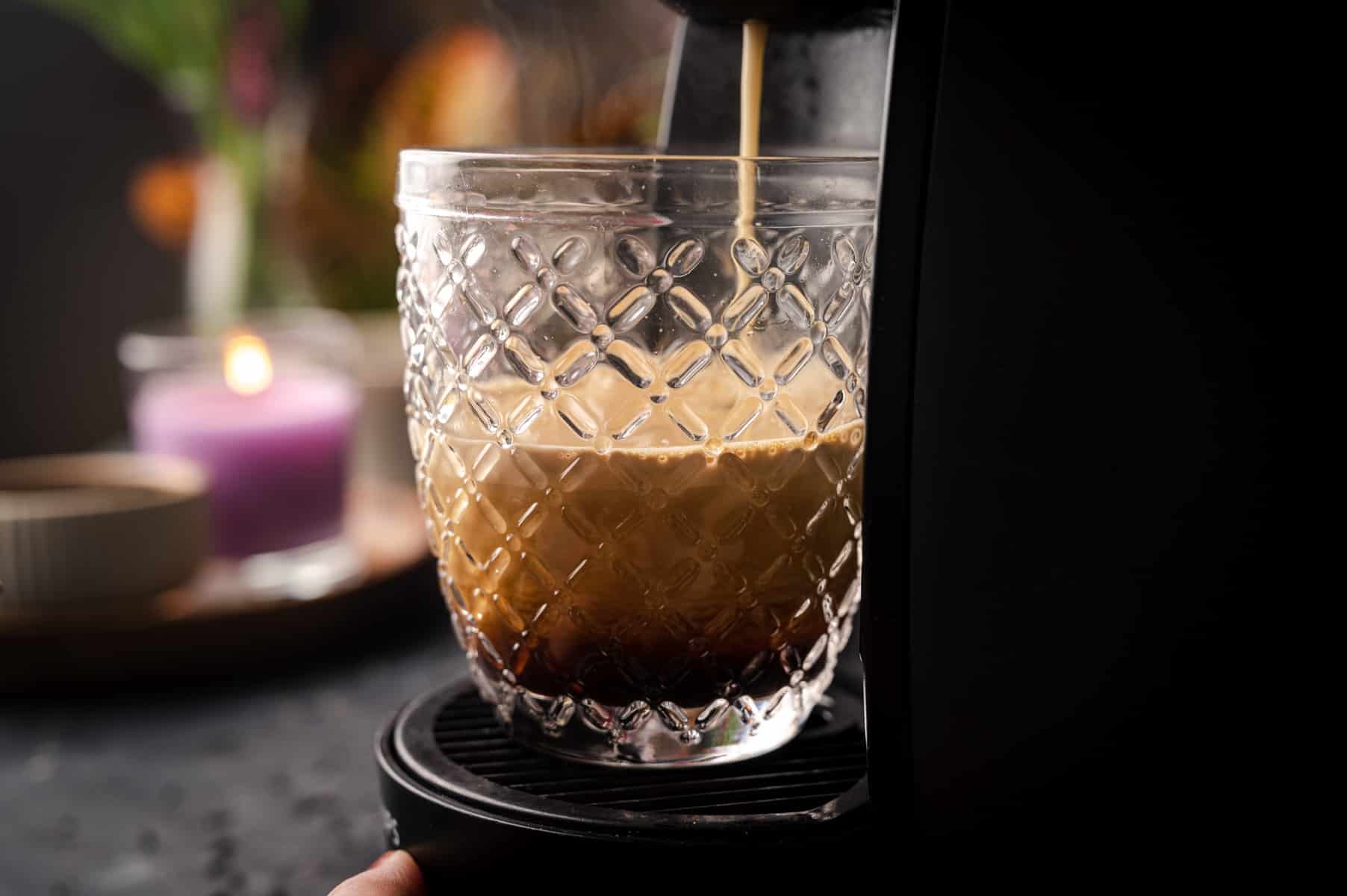 Fresh espresso being poured into a crystal cup.