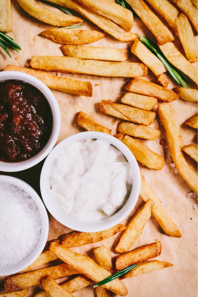 A plate of french fries with ketchup and mustard.
