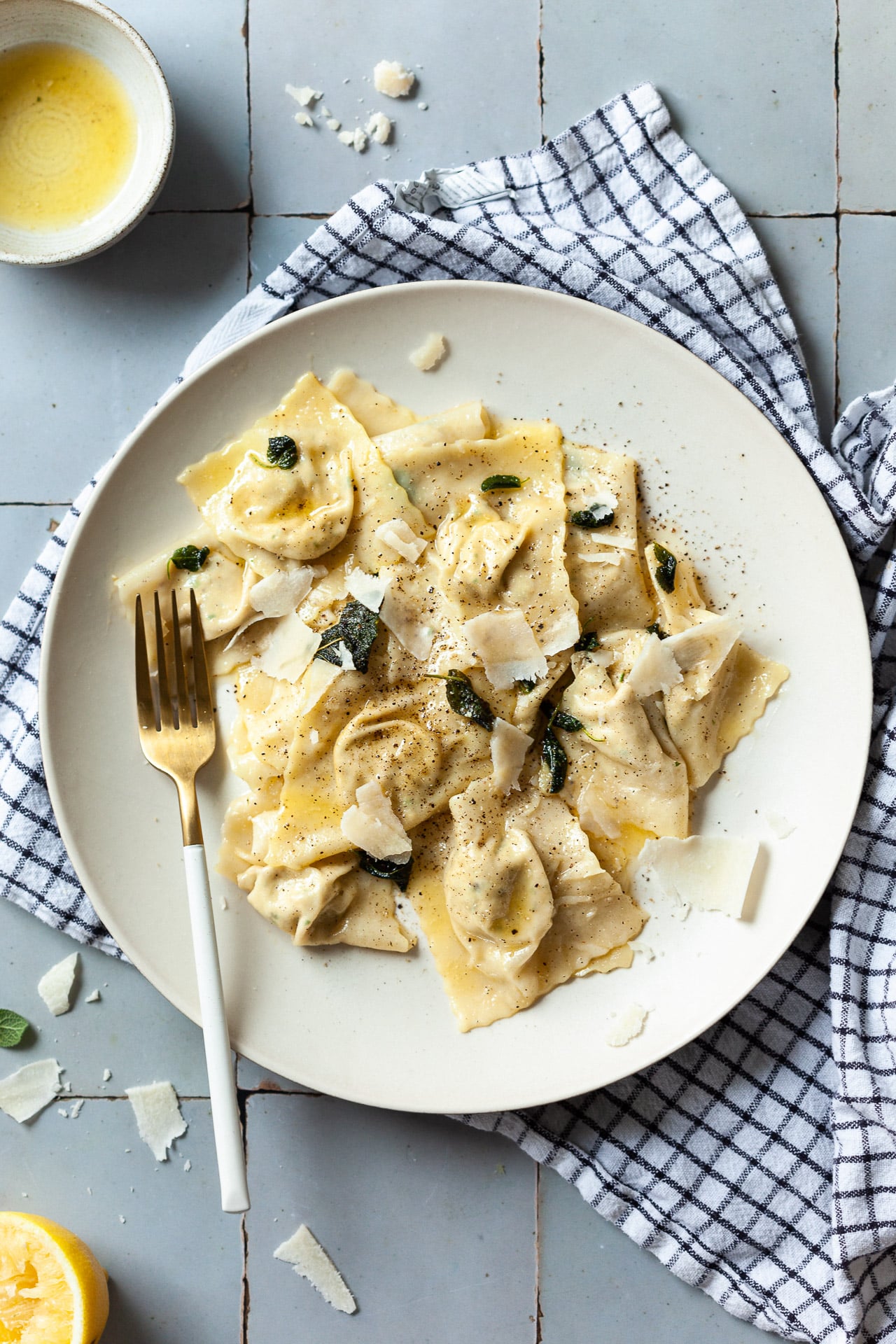 A plate of ravioli with lemon and parmesan.