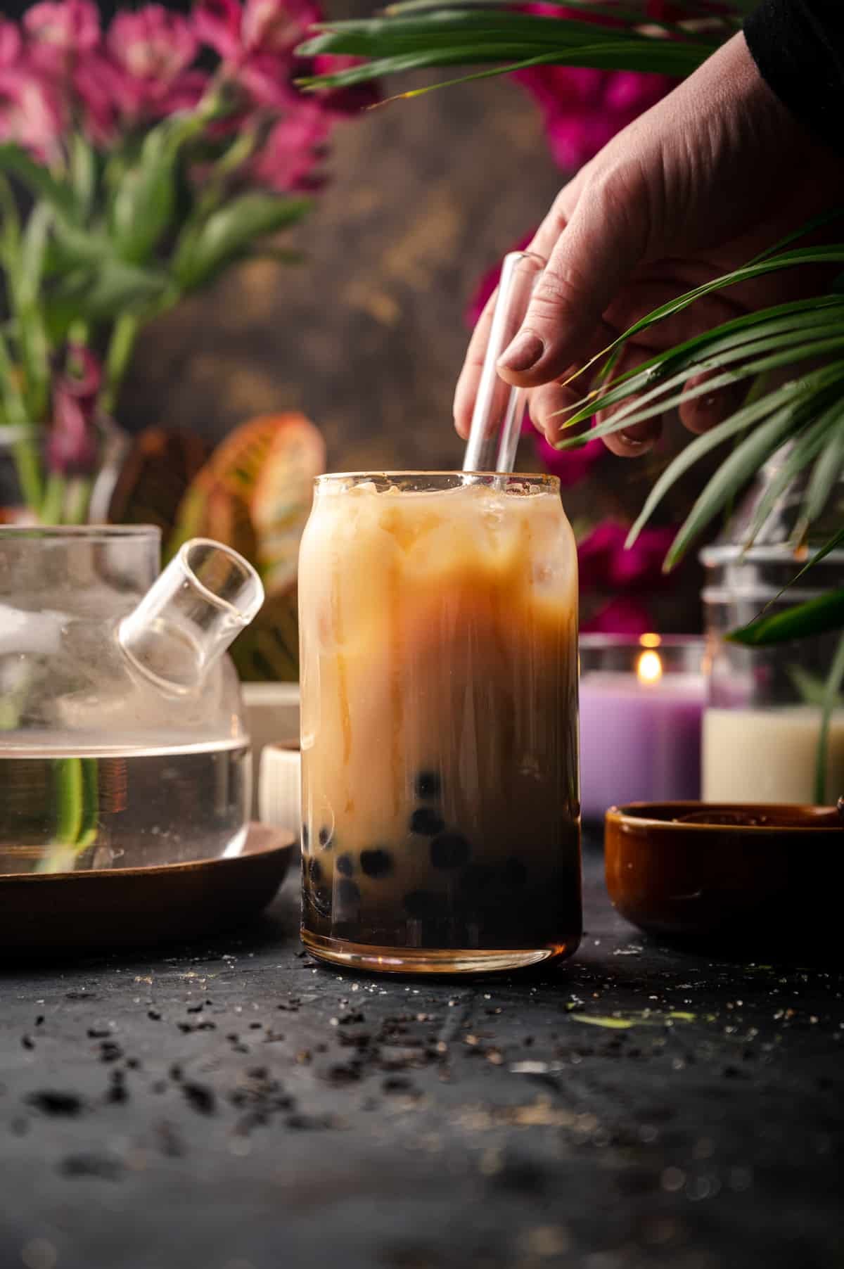 A person is pouring a drink into a glass.