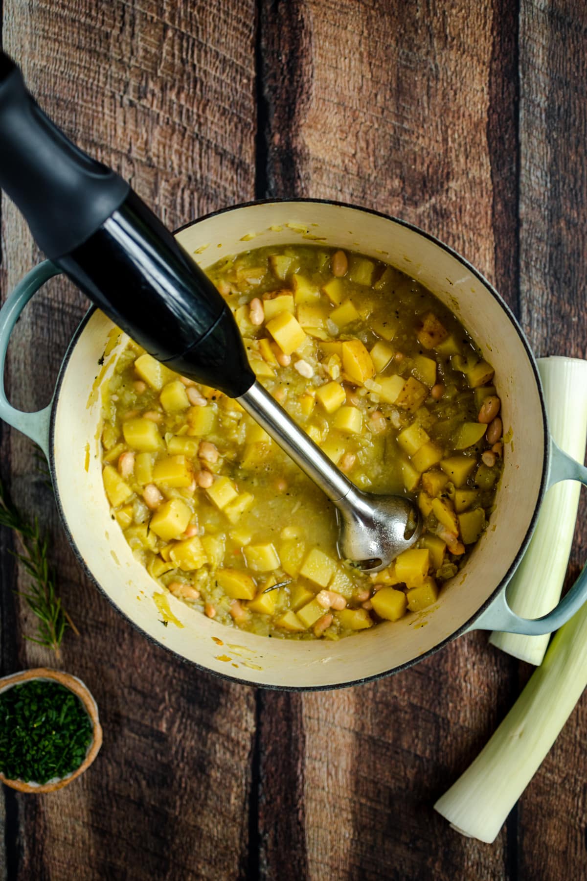 A pot of soup with vegetables in it.