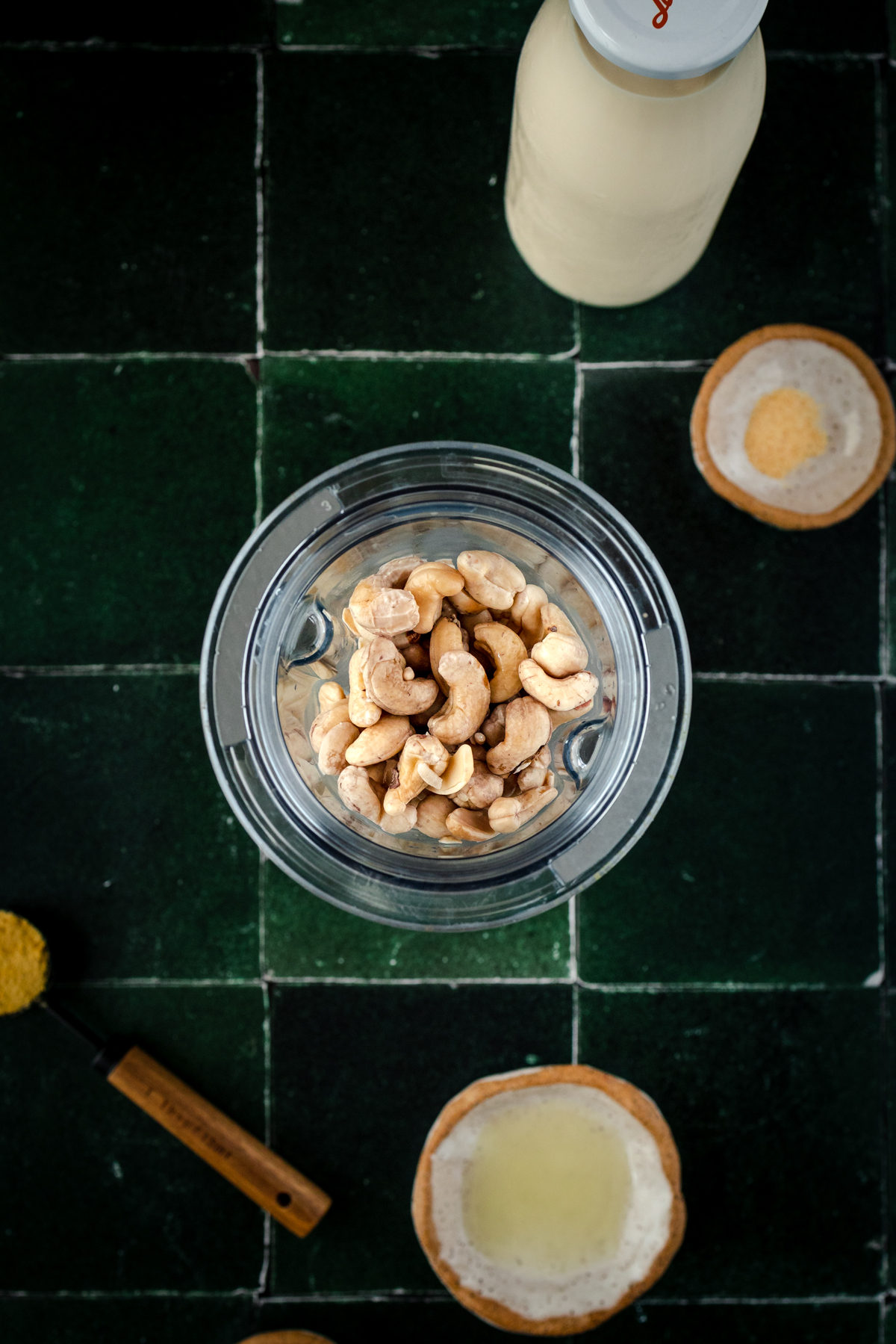 Soaked cashews added to a blender cup.