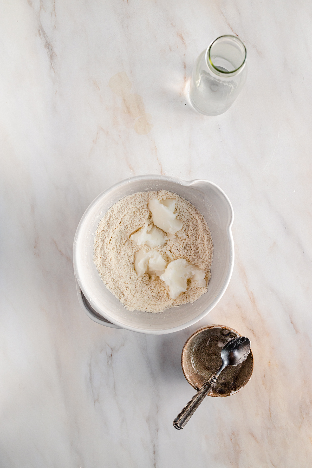 A white bowl on a marble table.