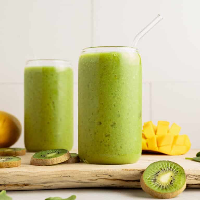 Kiwi mango smoothie in two glasses.