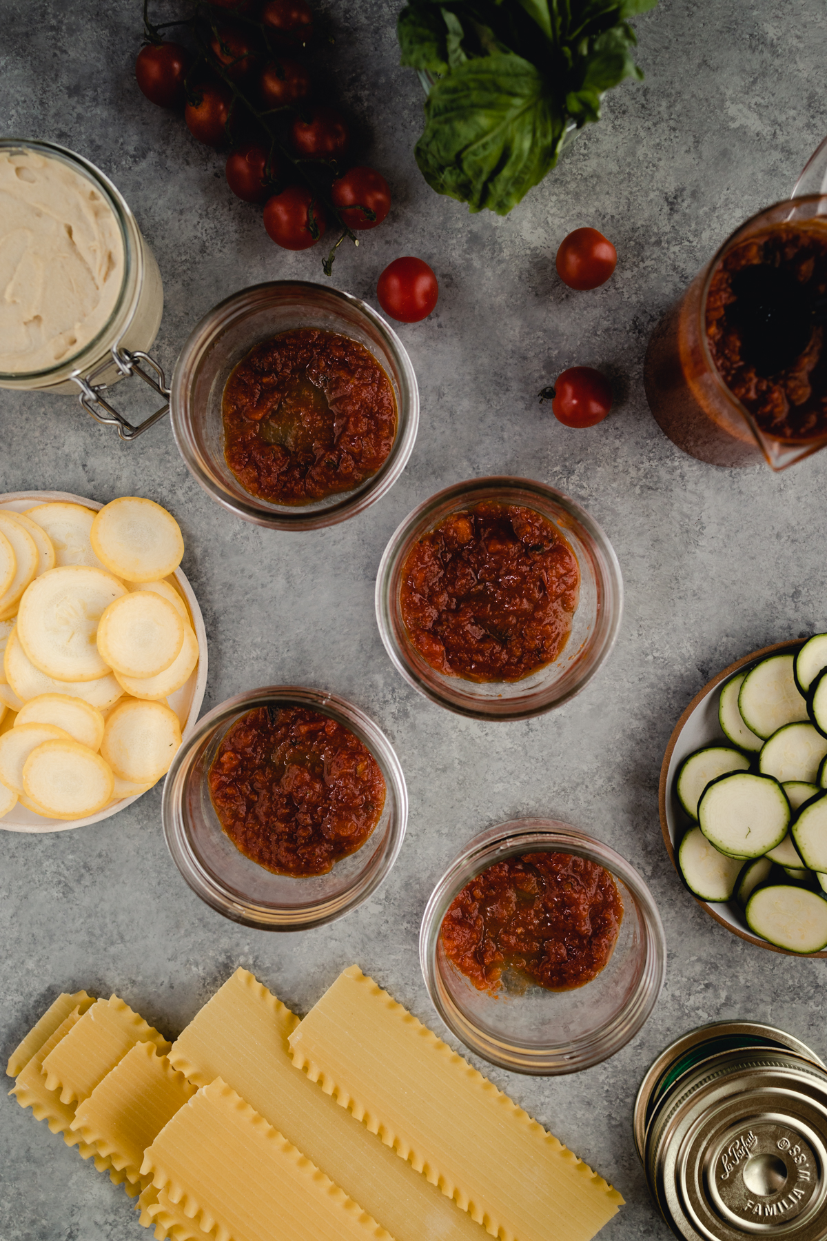 First layer of marinara in jars.