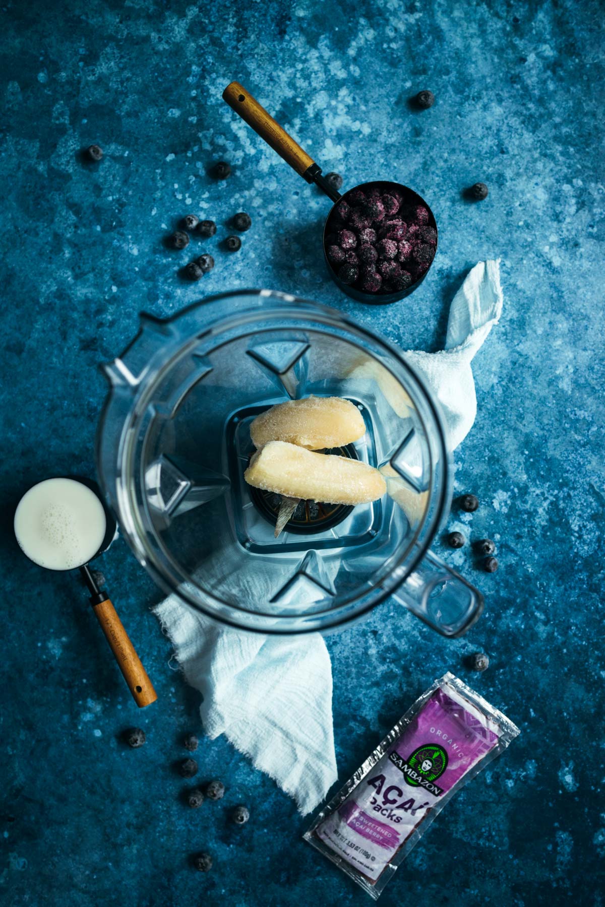 A blender with frozen bananas in it.
