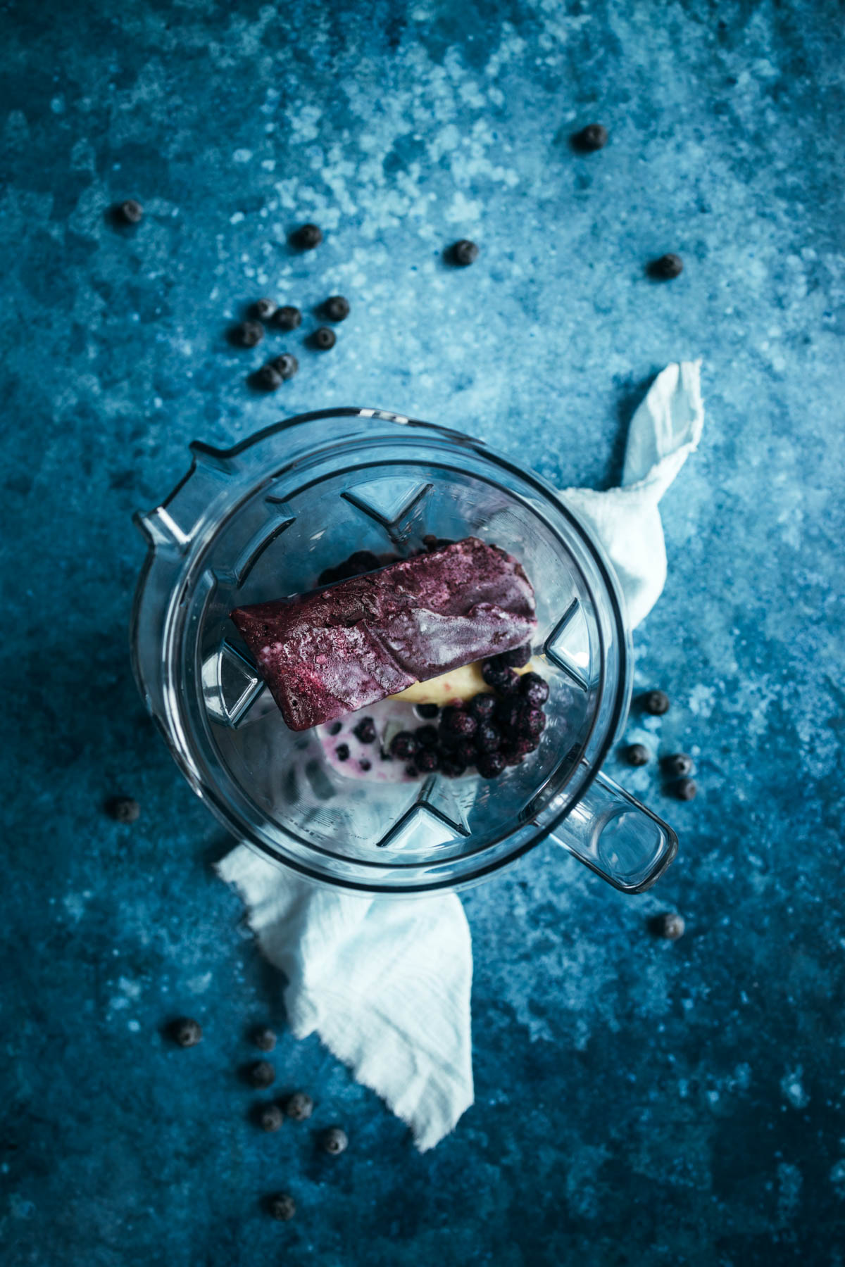 A blender with a piece of acai puree in it.