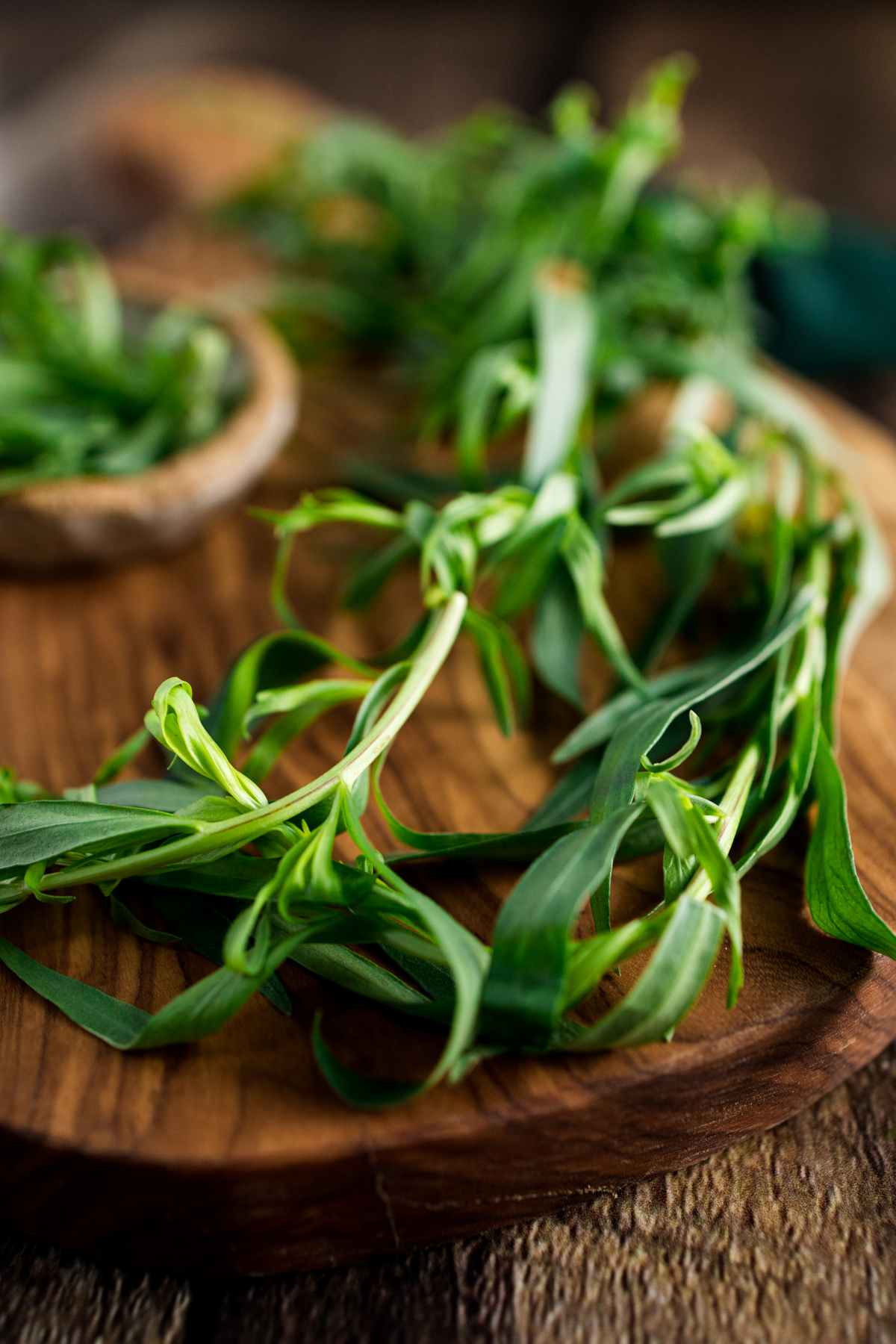 Thyme leaves on a wooden cutting board.