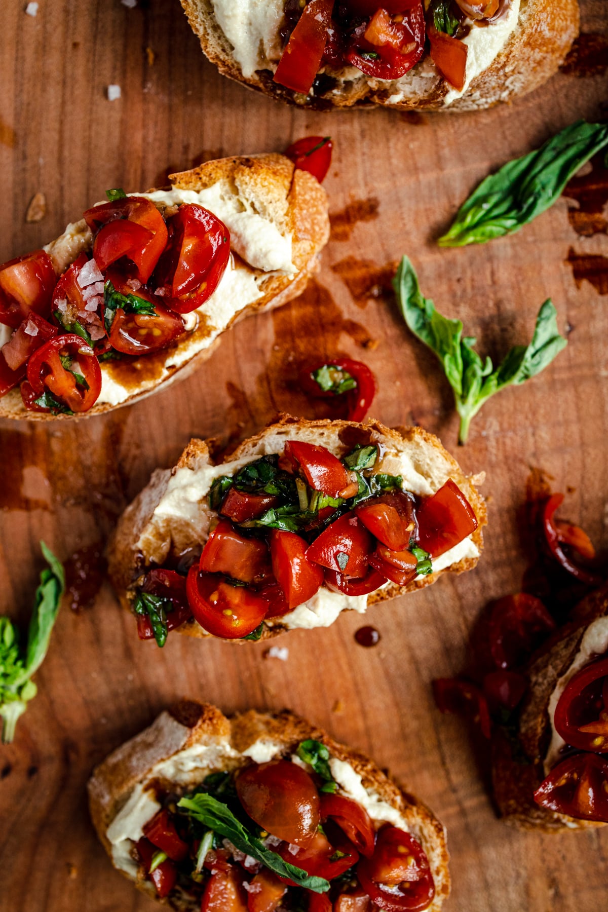 Fresh bruschetta on crispy bread with vegan ricotta cheese.