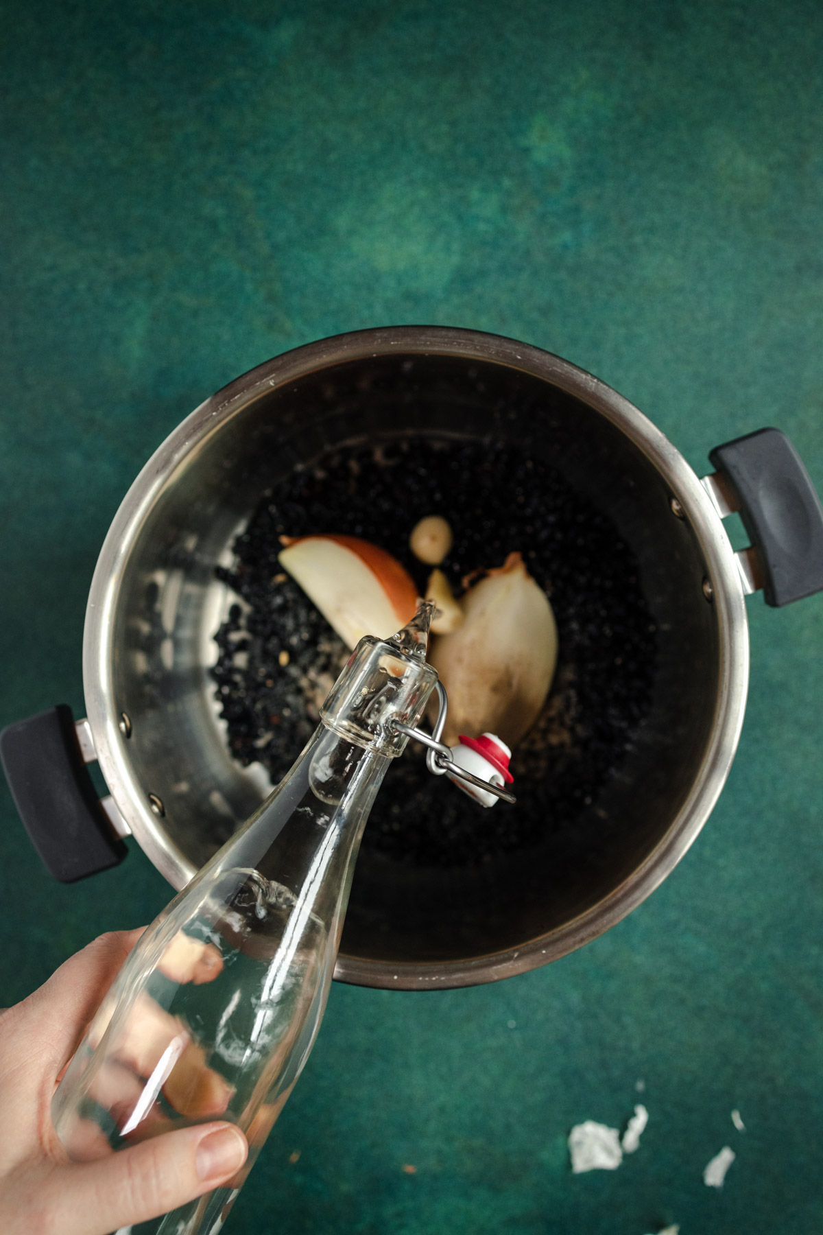 A person pouring water into a pot.