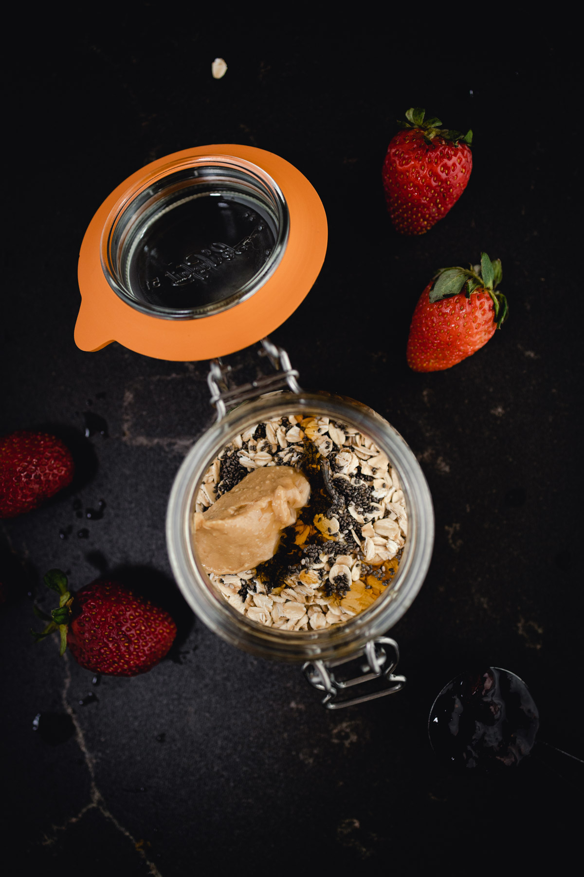 Oatmeal in a jar with strawberries and nuts.