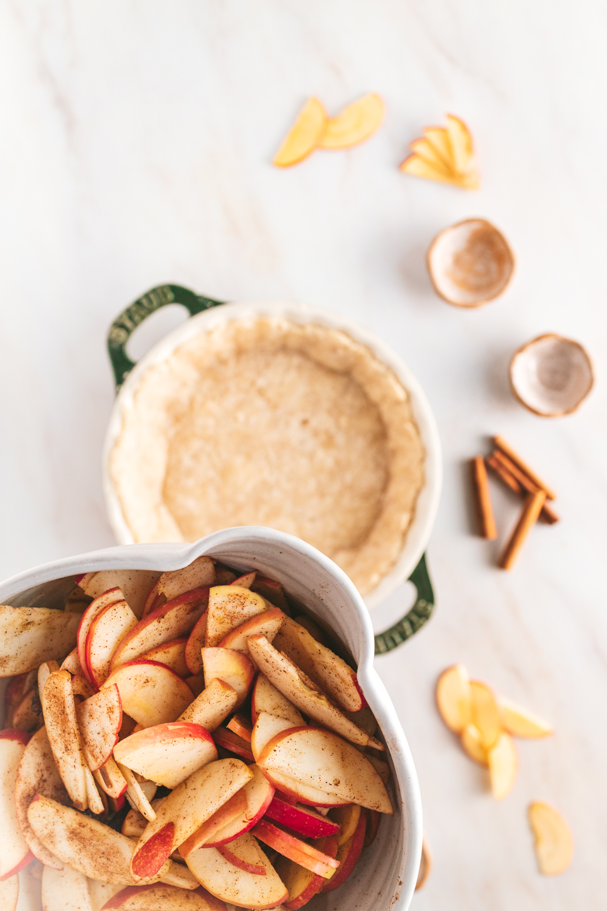 A bowl filled with apples and cinnamon.