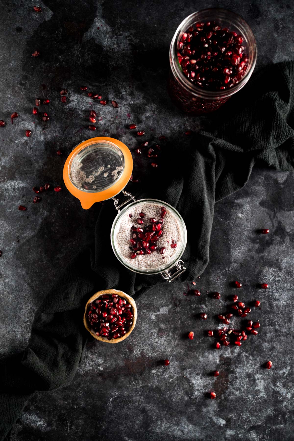 Pomegranate seeds and pomegranate seeds on a black background.