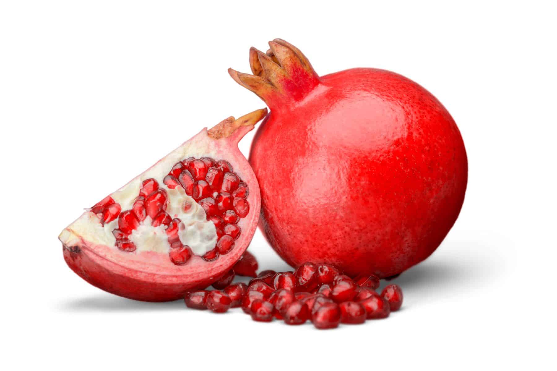A whole pomegranate and a sliced pomegranate with visible seeds are displayed against a white background.
