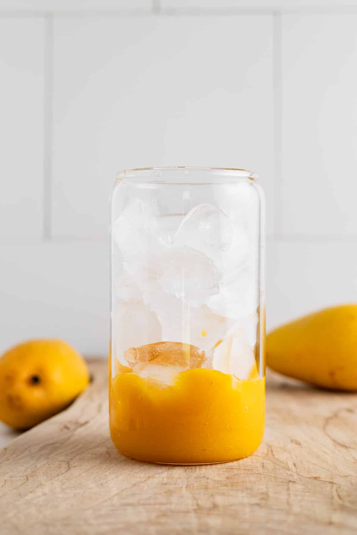 Ice being added to a glass cup.