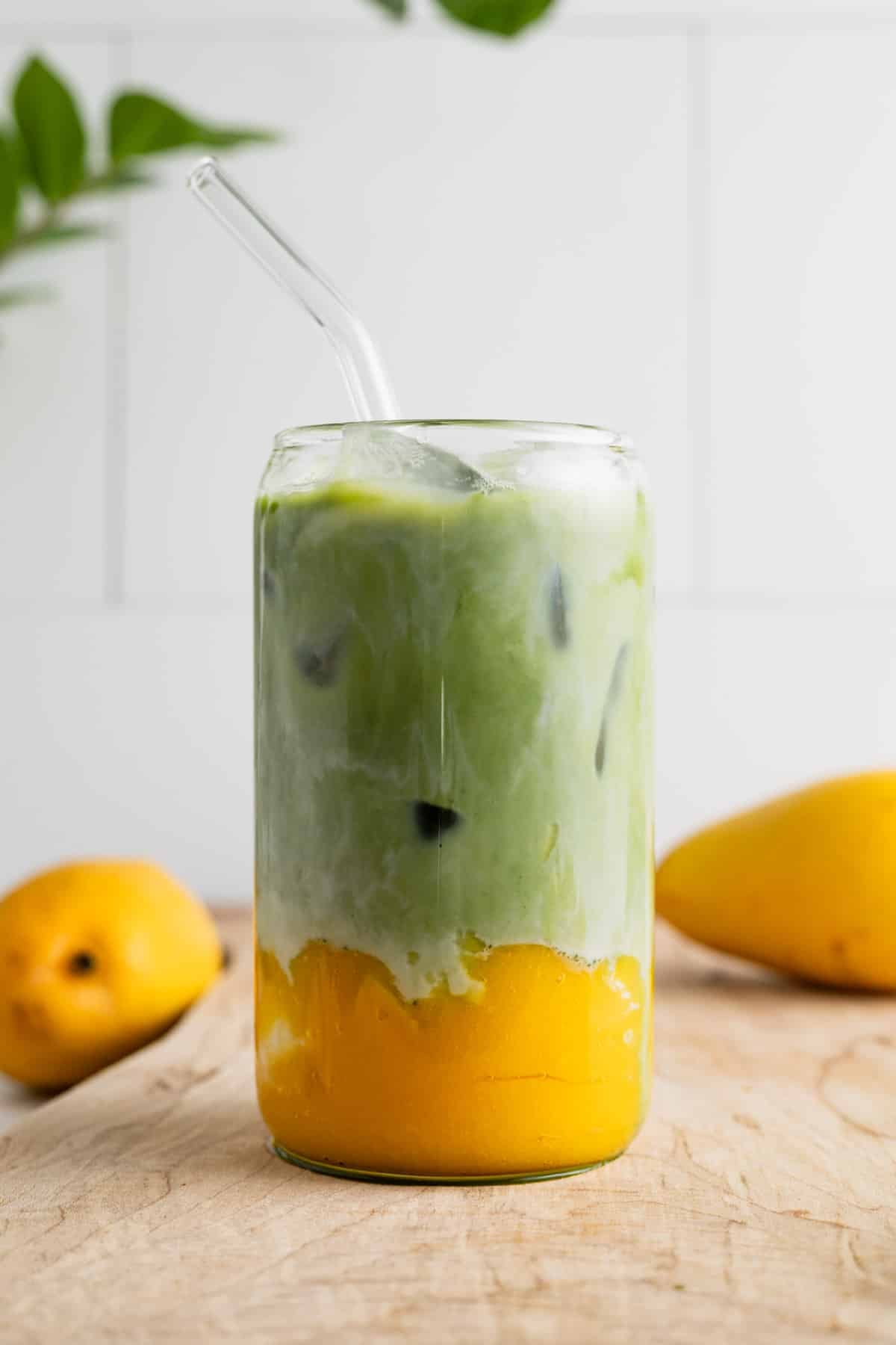 A cup of matcha latte with homemade mango puree.