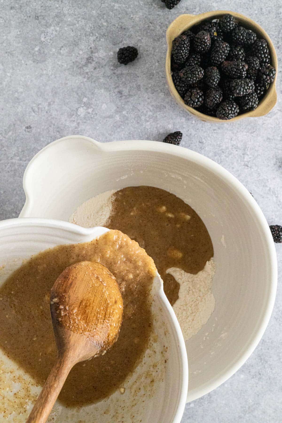 Wet ingredients being added to the dry ingredients.