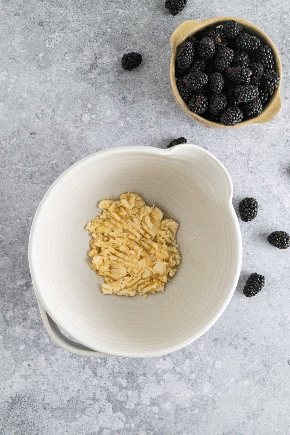 Mashing banana in a large bowl.
