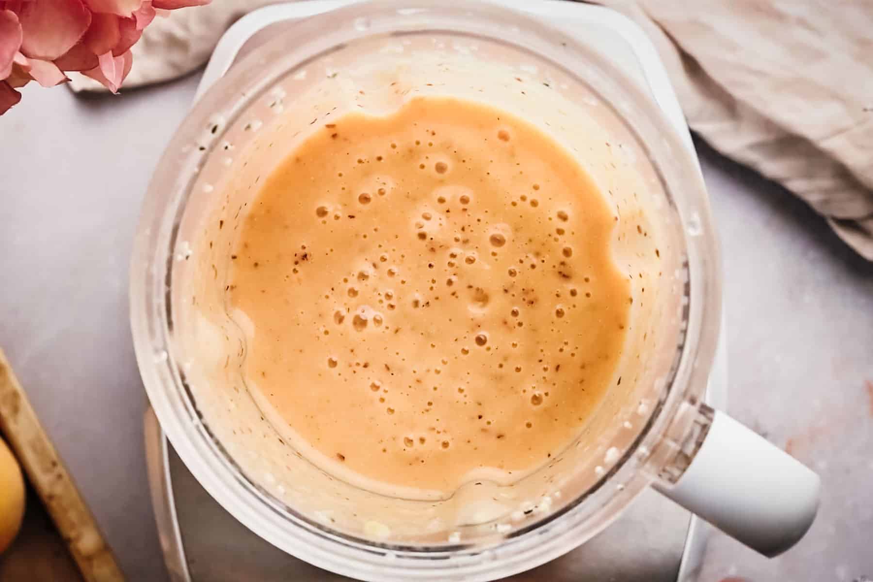 Blended peach smoothie in the pitcher.