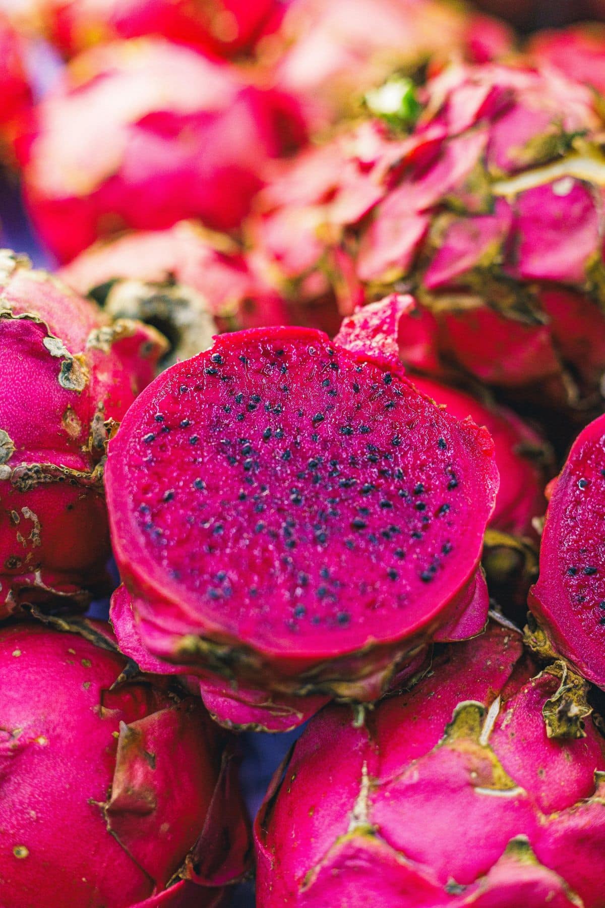 Pink skinned dragon fruit with pink flesh and black seeds.