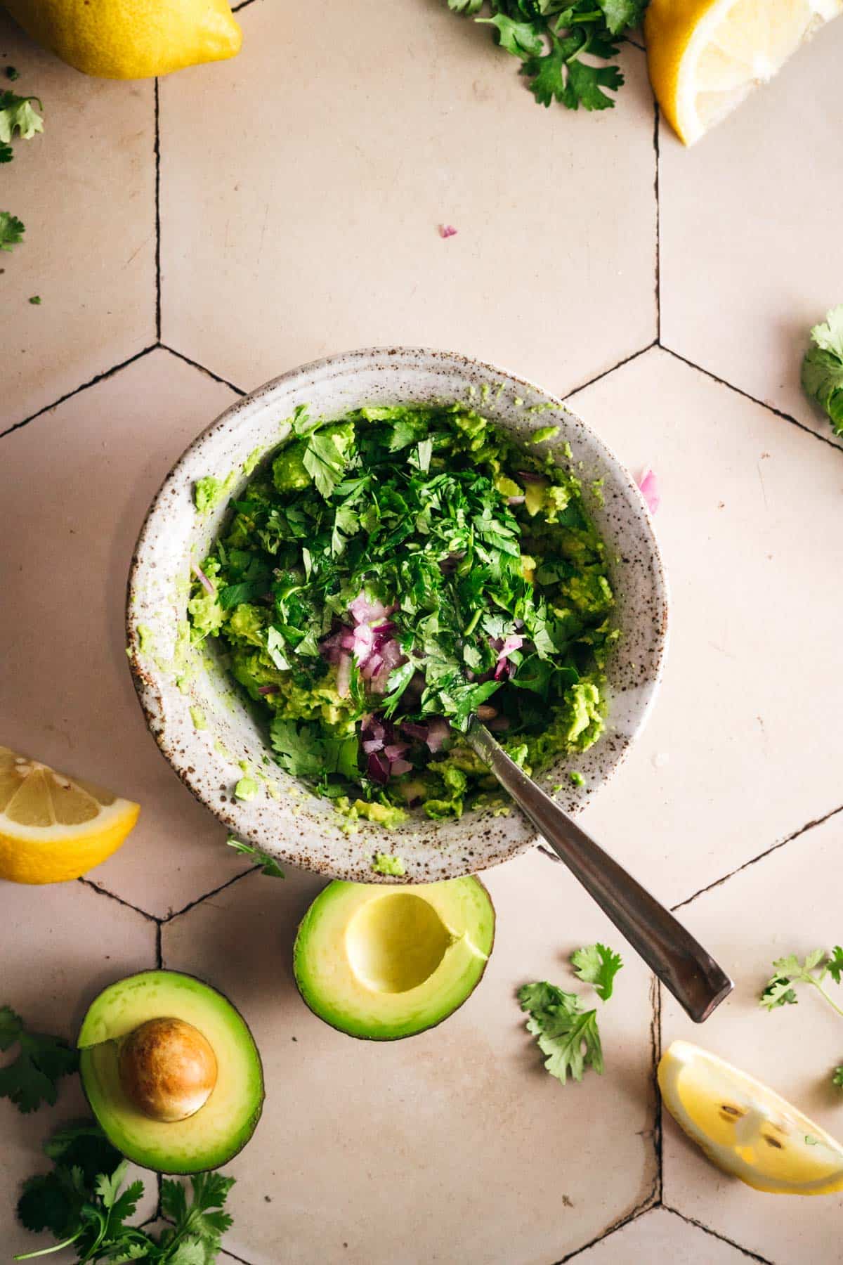 Fresh ingredients in a bowl for authentic guacamole.