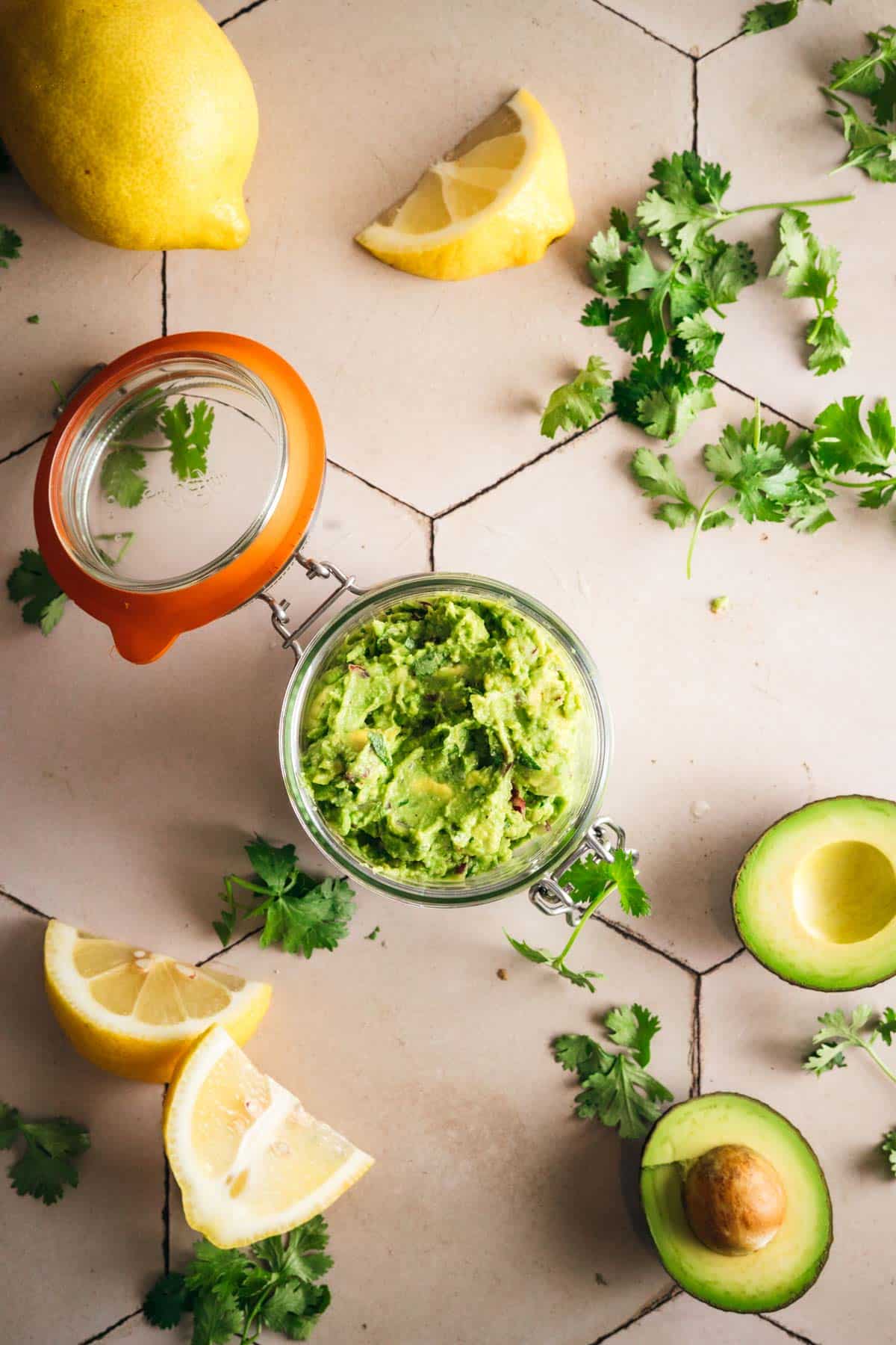 Sealing a glass jar full of the best guacamole recipe.