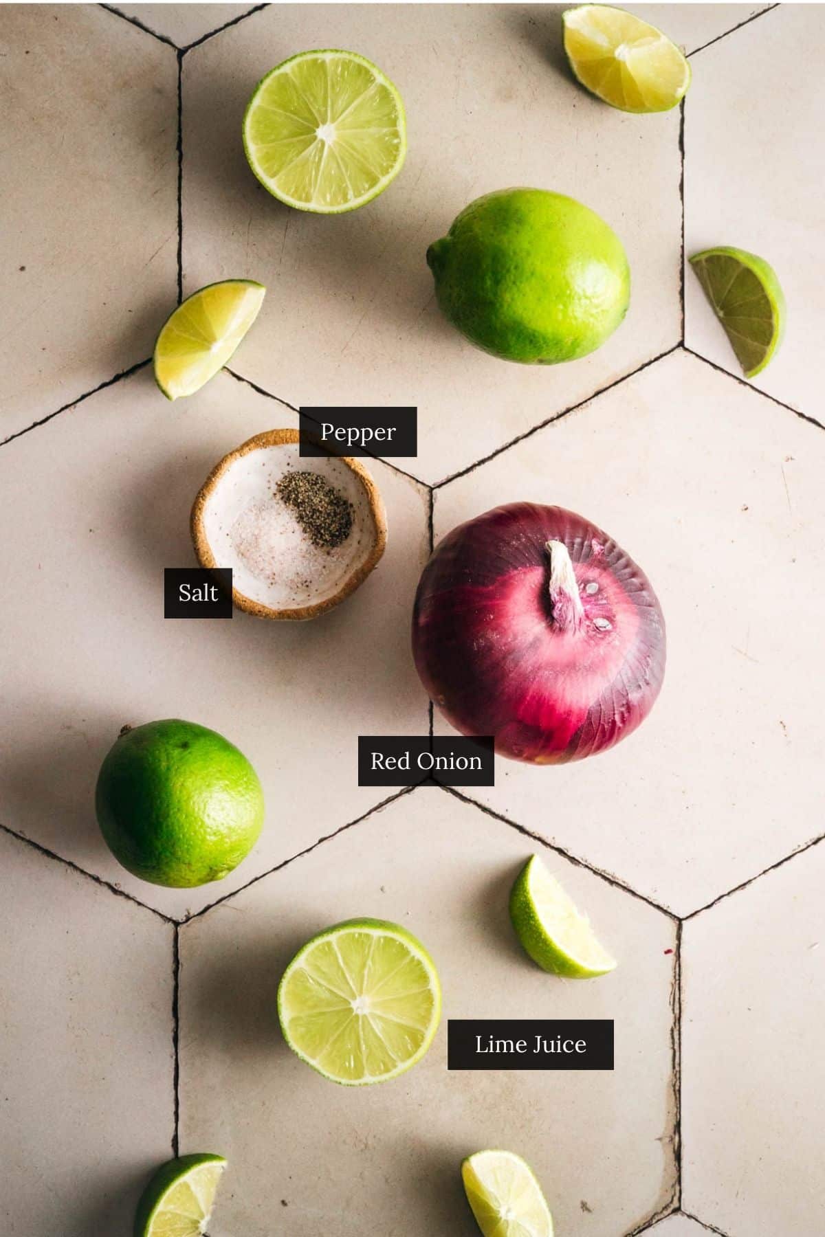 Ingredient for pickled red onion with lime juice labeled on a tile counter.