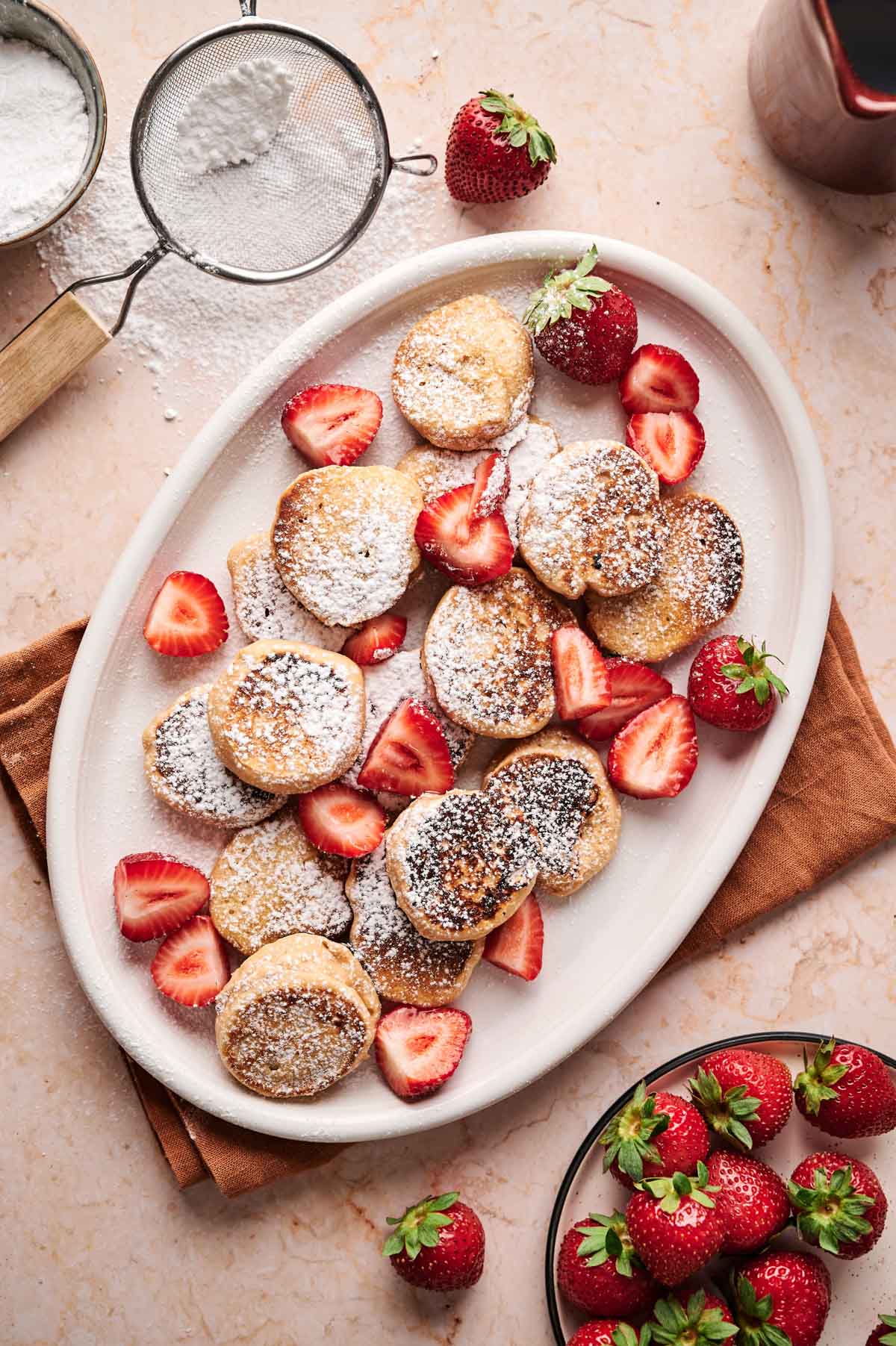 Cute pancakes on an oval white plate.