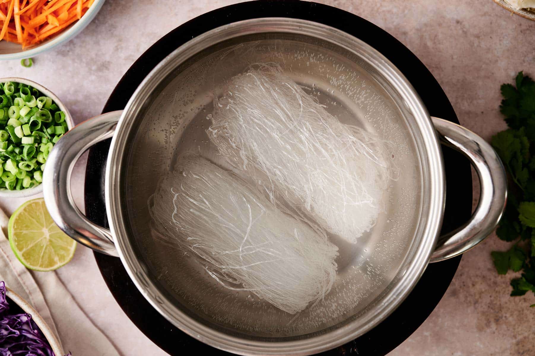 Vermicelli rice noodles soaking in water.