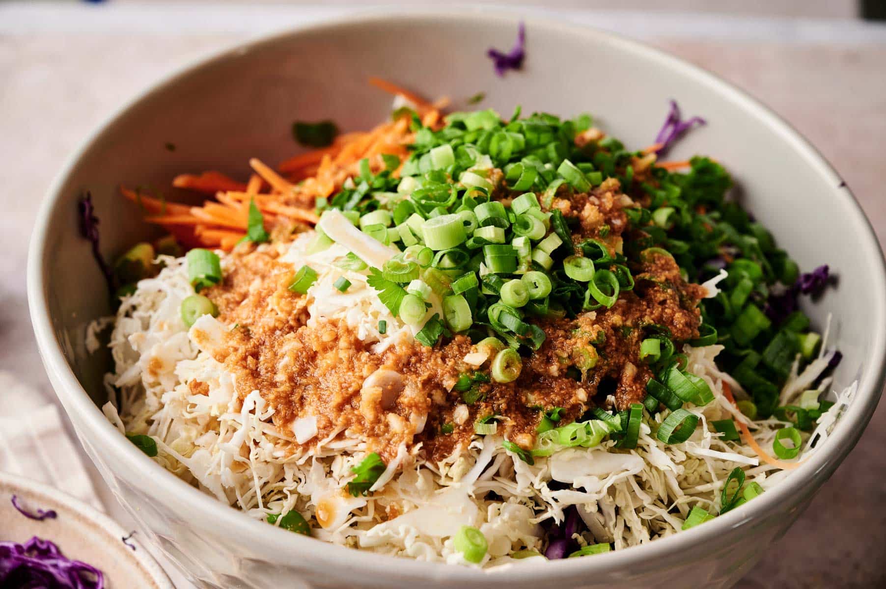 Ingredients for the spring roll salad in a large mixing bowl.