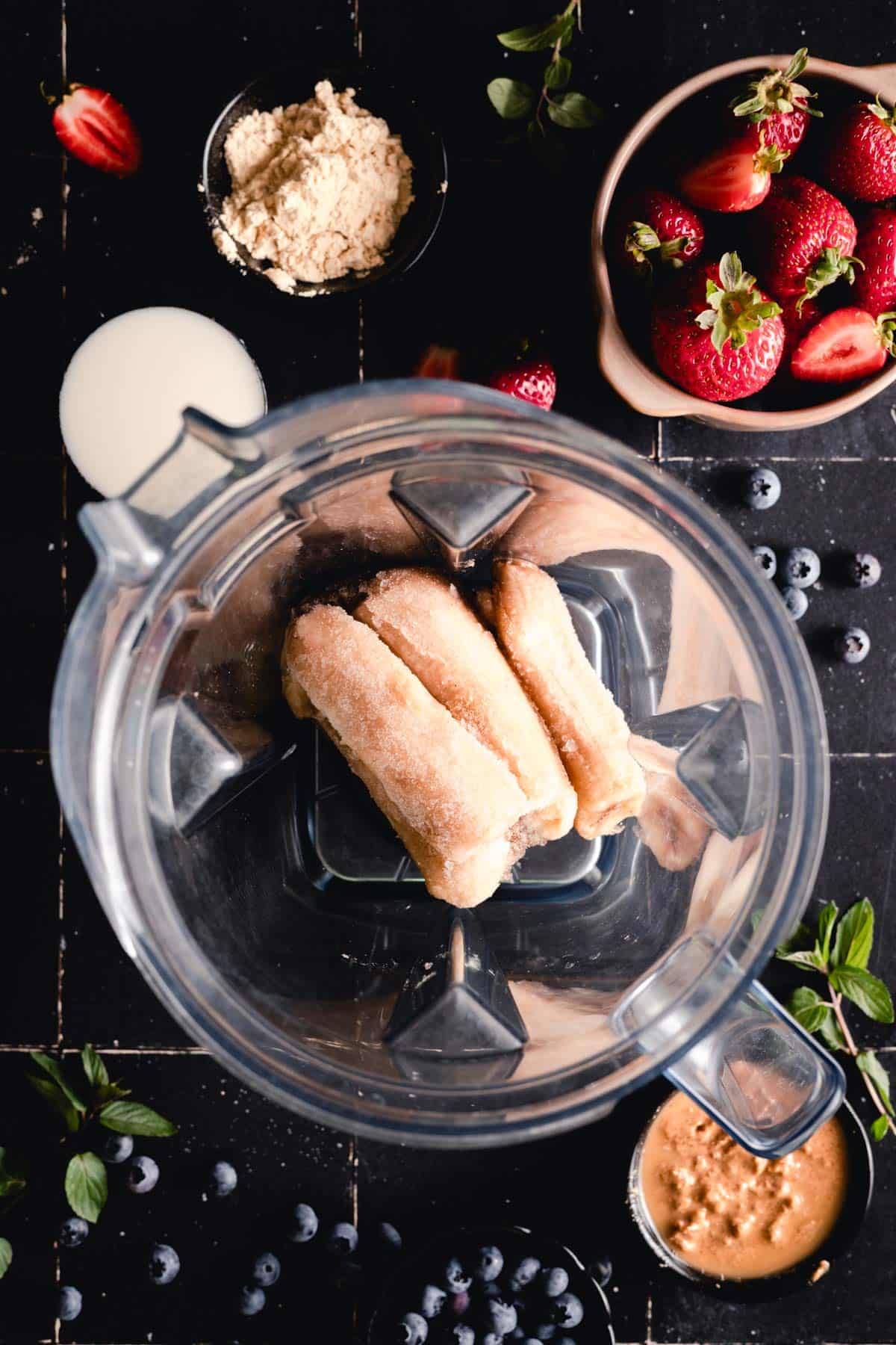 Frozen bananas added to a blender.