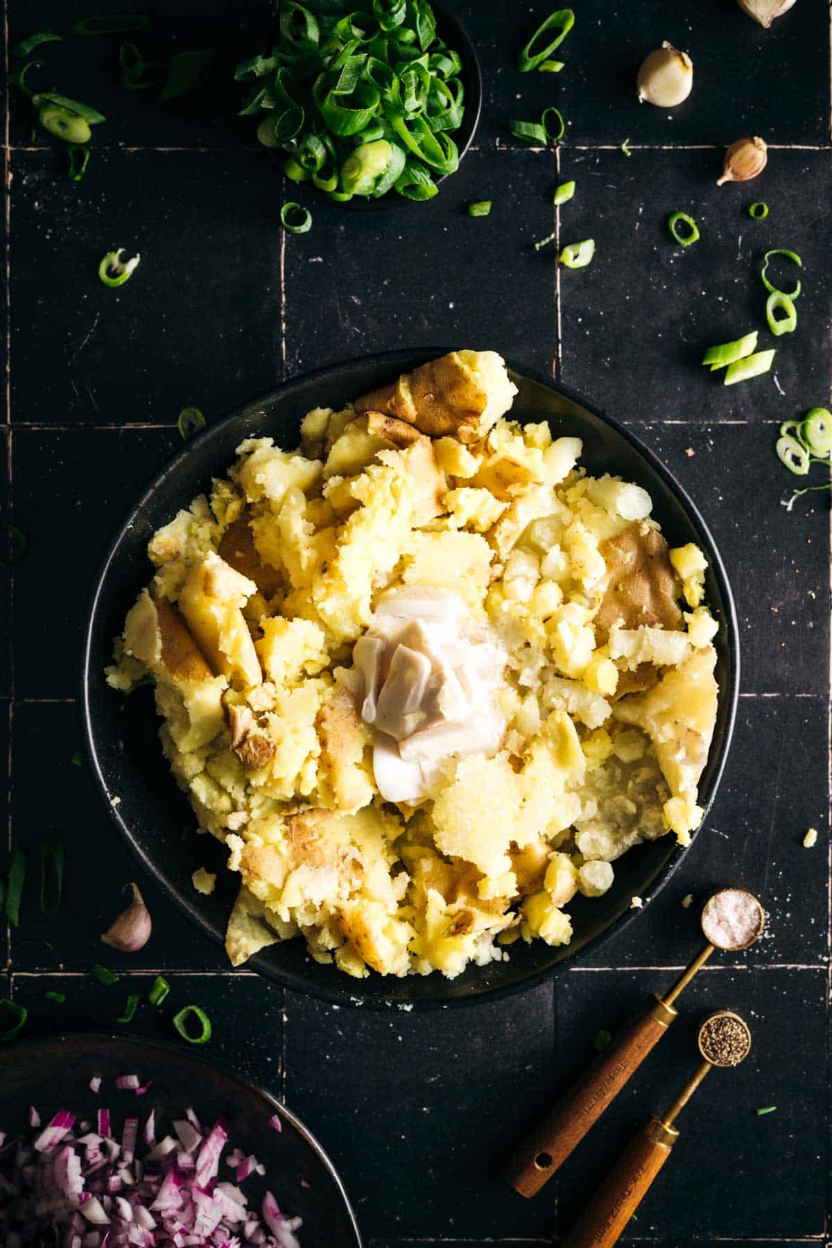 Butter and garlic added on top of mashed potatoes.