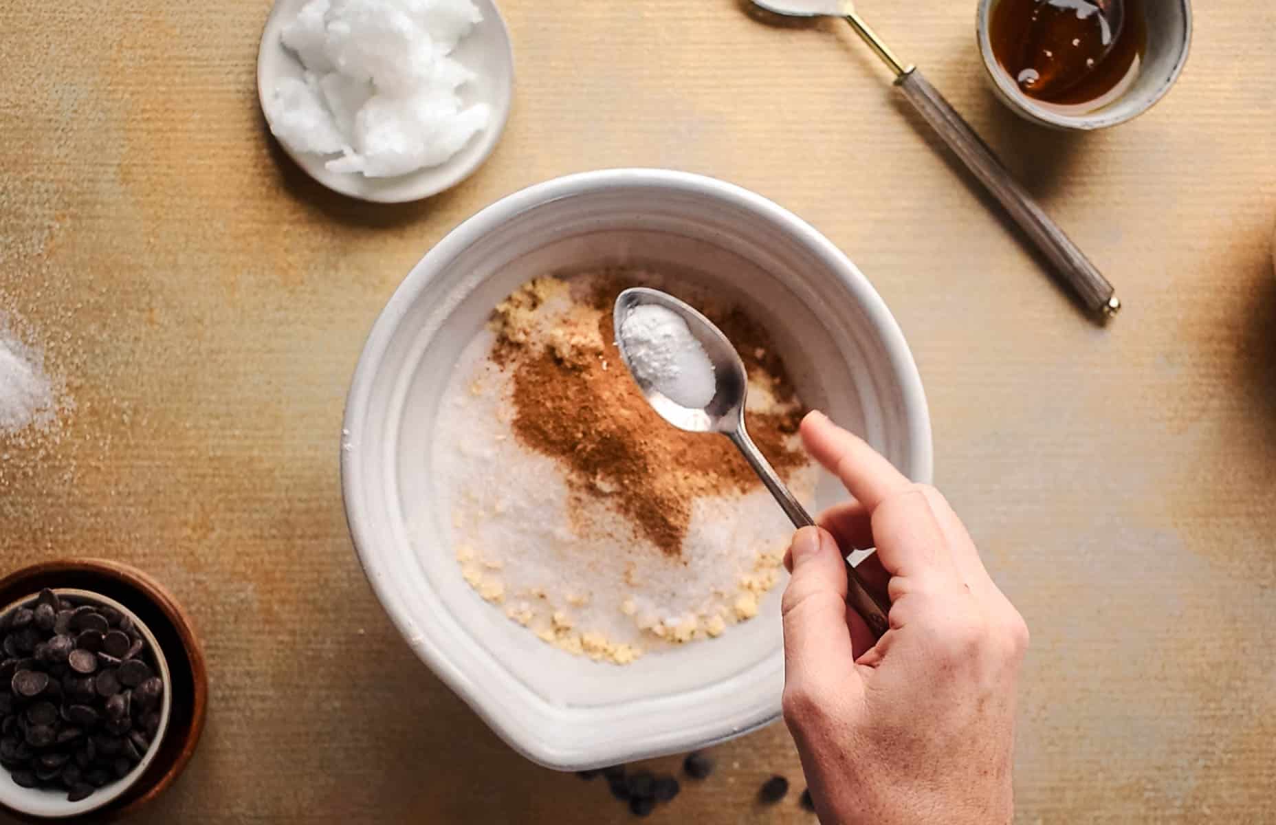 Dry ingredients for pumpkin cookies added to a large mixing bowl.