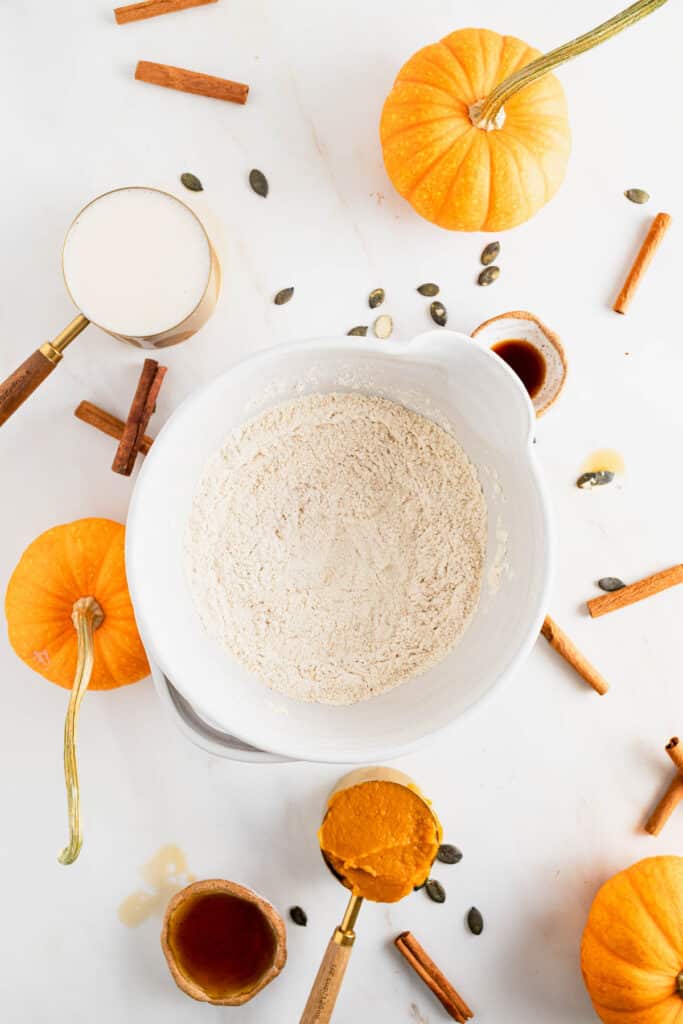Dry ingredients for protein pumpkin pancakes added to a large mixing bowl.