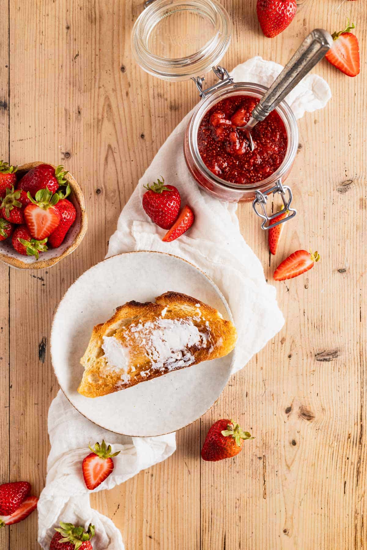 Vegan butter on toast with strawberry jam next to it.