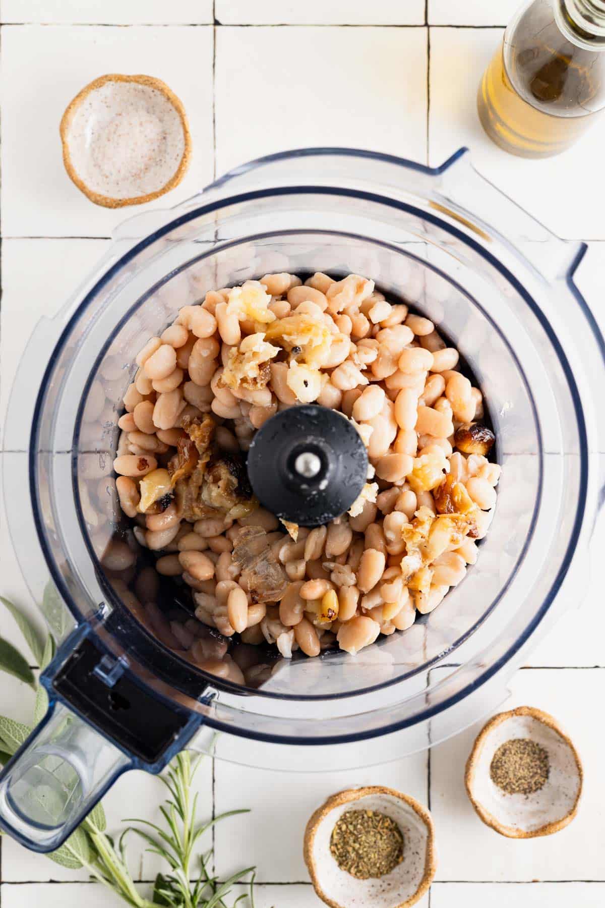 White beans and roasted garlic in a food processor.